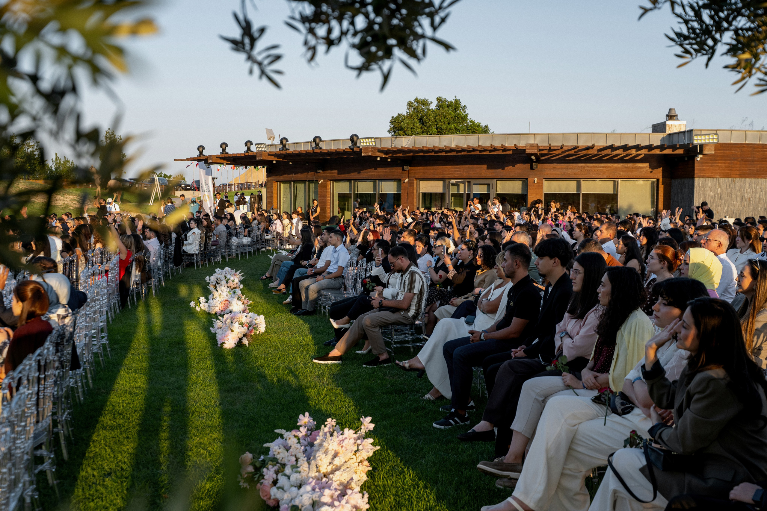 Outdoor venue with rows of transparent chairs beside a lake at the Global HR and Leadership Forum 2026.
