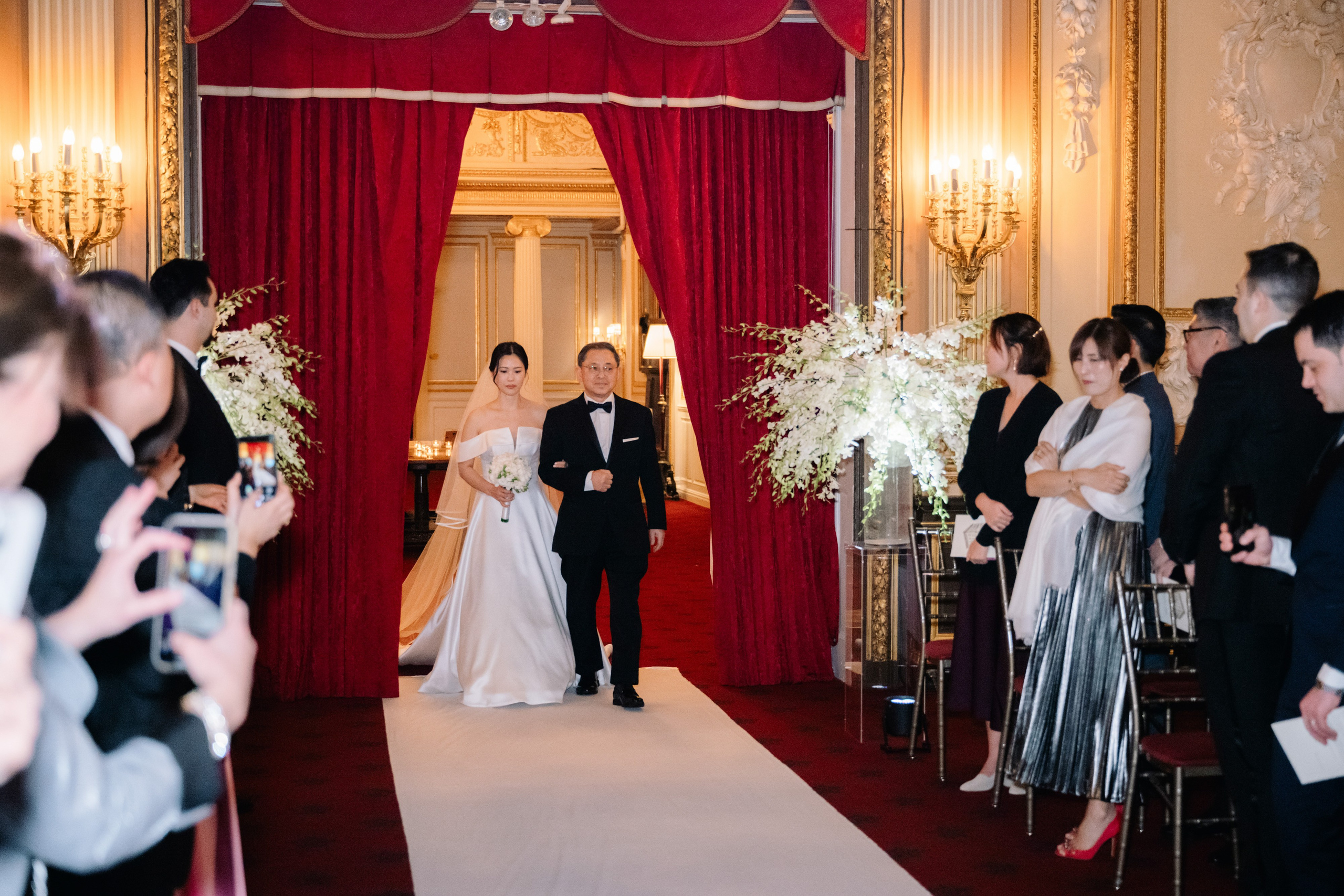 a bride and groom walking down the aisle