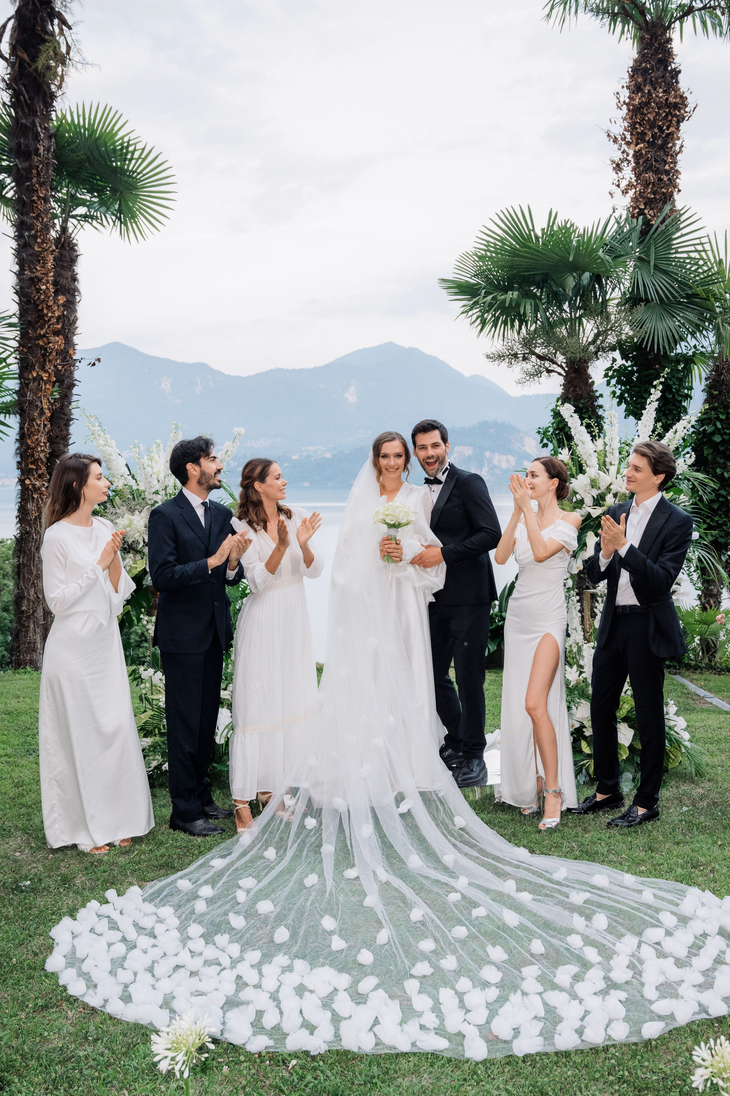 a bride and groom with their wedding party