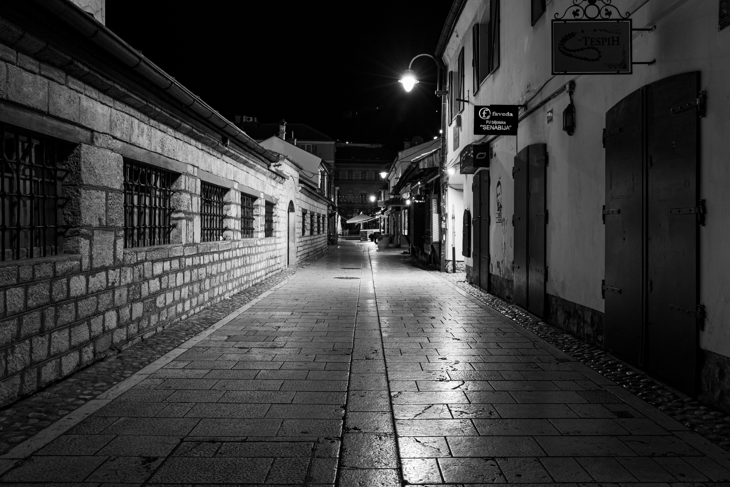 Black and white cityscape photography showing Sarajevo streets at night