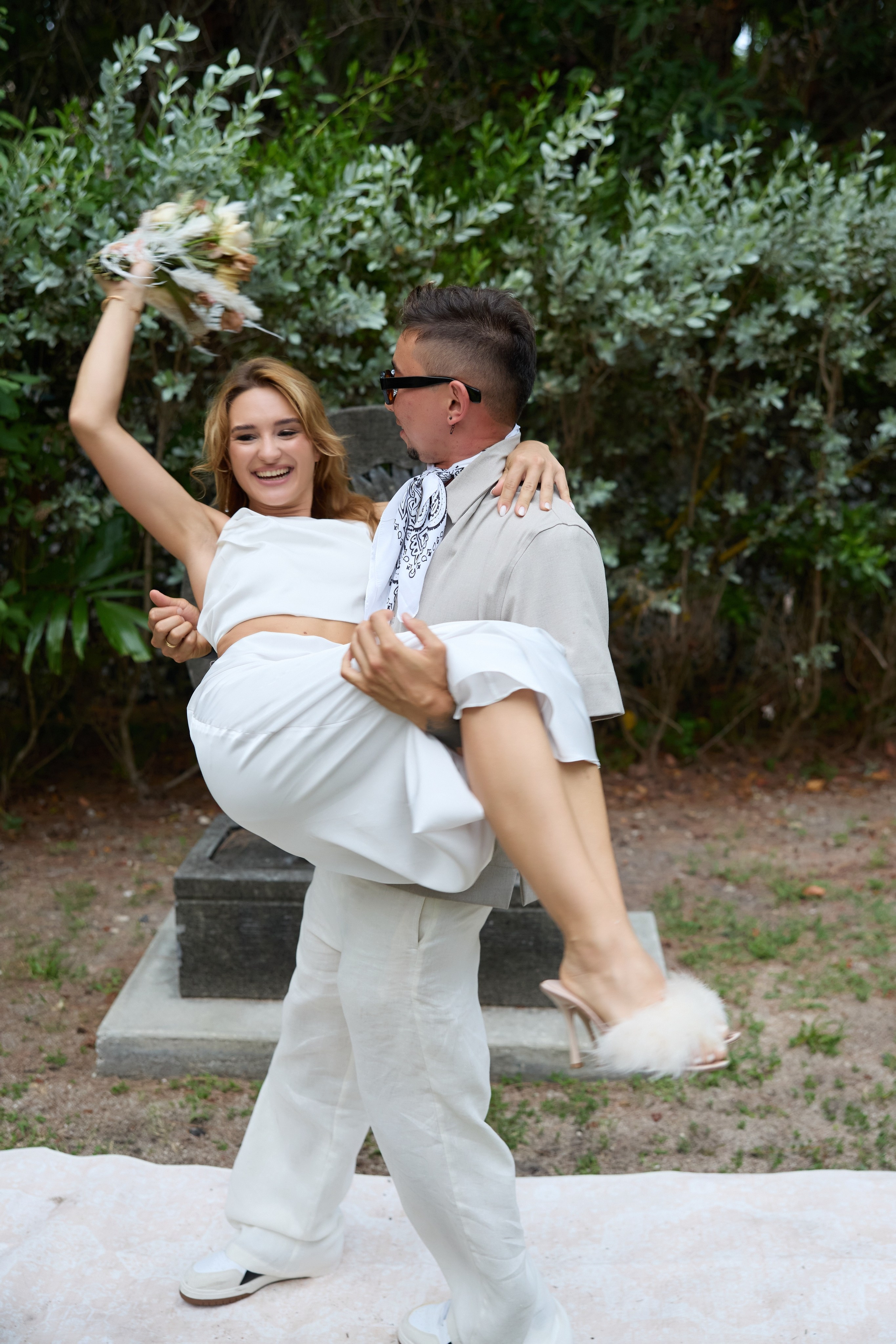 Joyful newlyweds celebrating after their intimate outdoor wedding