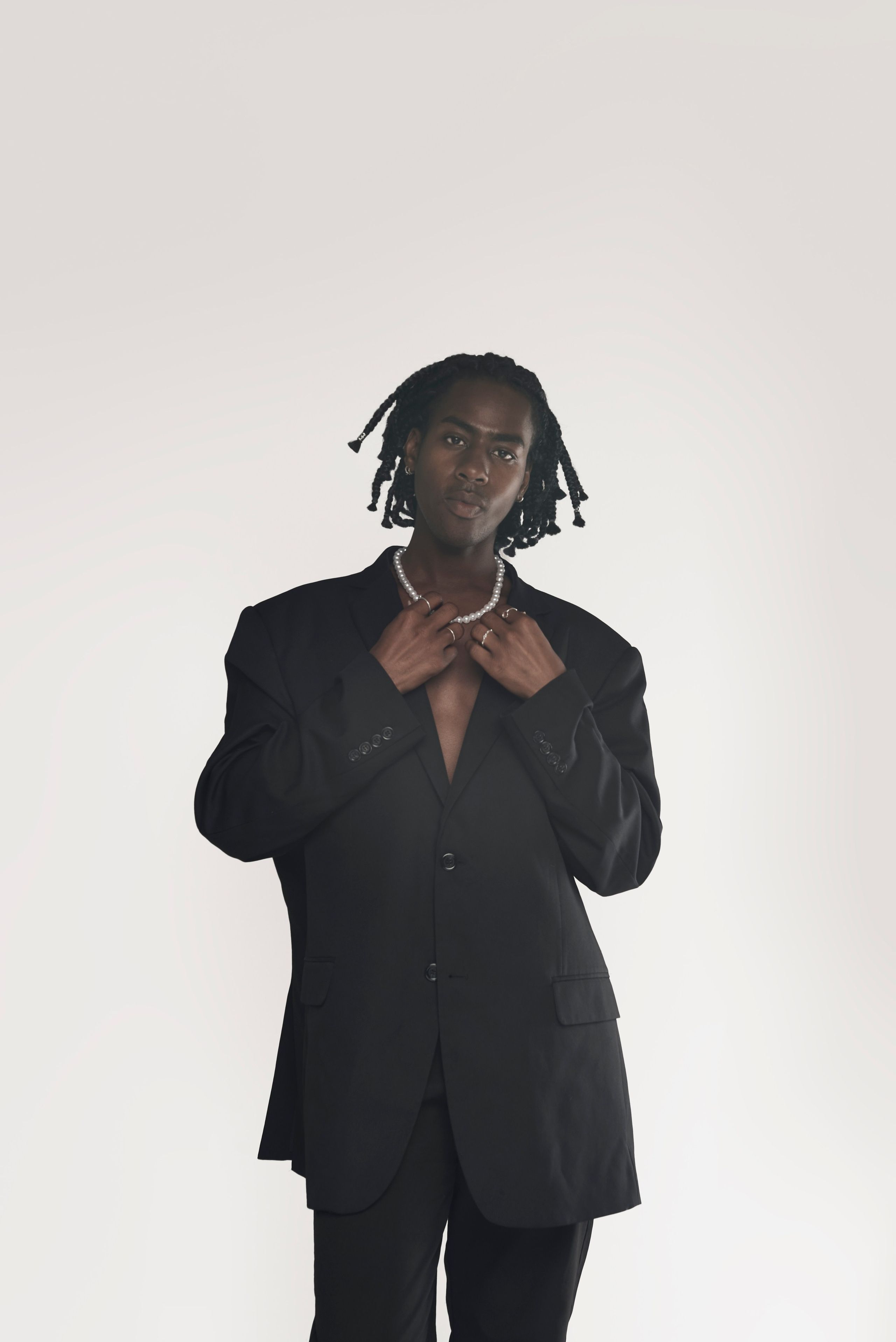 Male model adjusting his collar — stylish studio session in LA