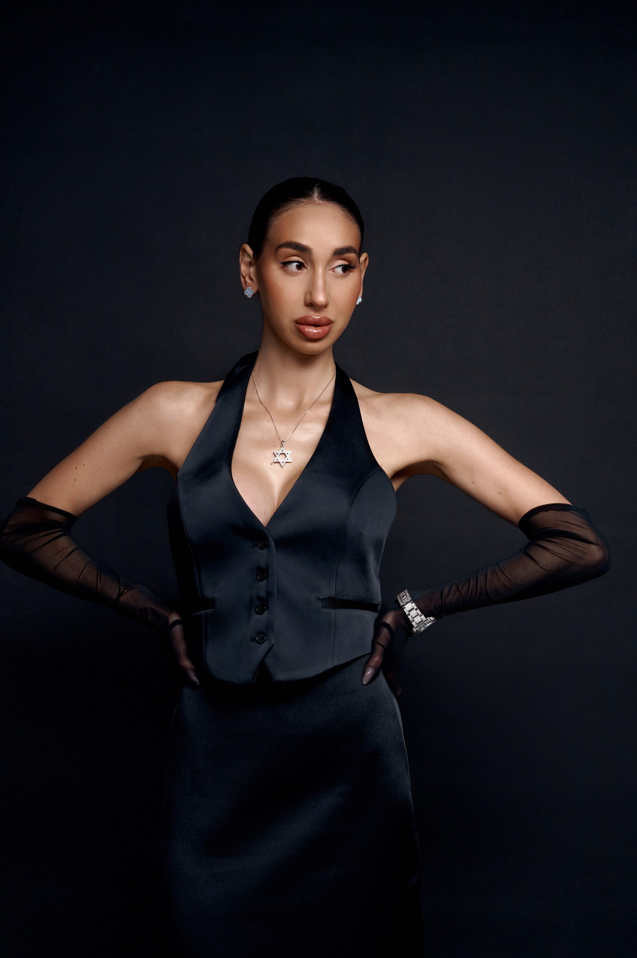 Studio portrait of Ester Rogovaya on a black background, minimalist styling and clean studio lighting