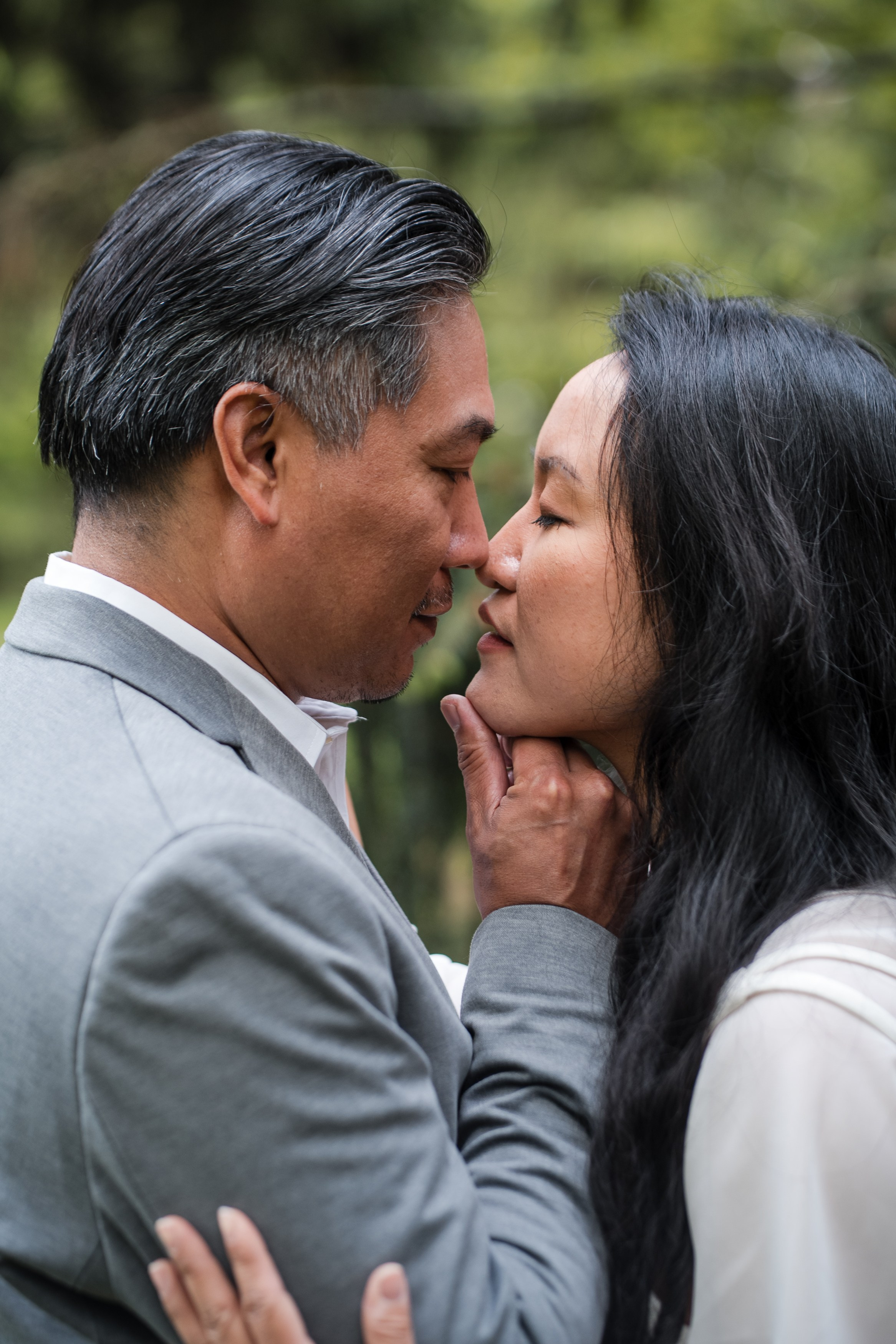 Engaged couple hugging in a forest during a romantic photoshoot