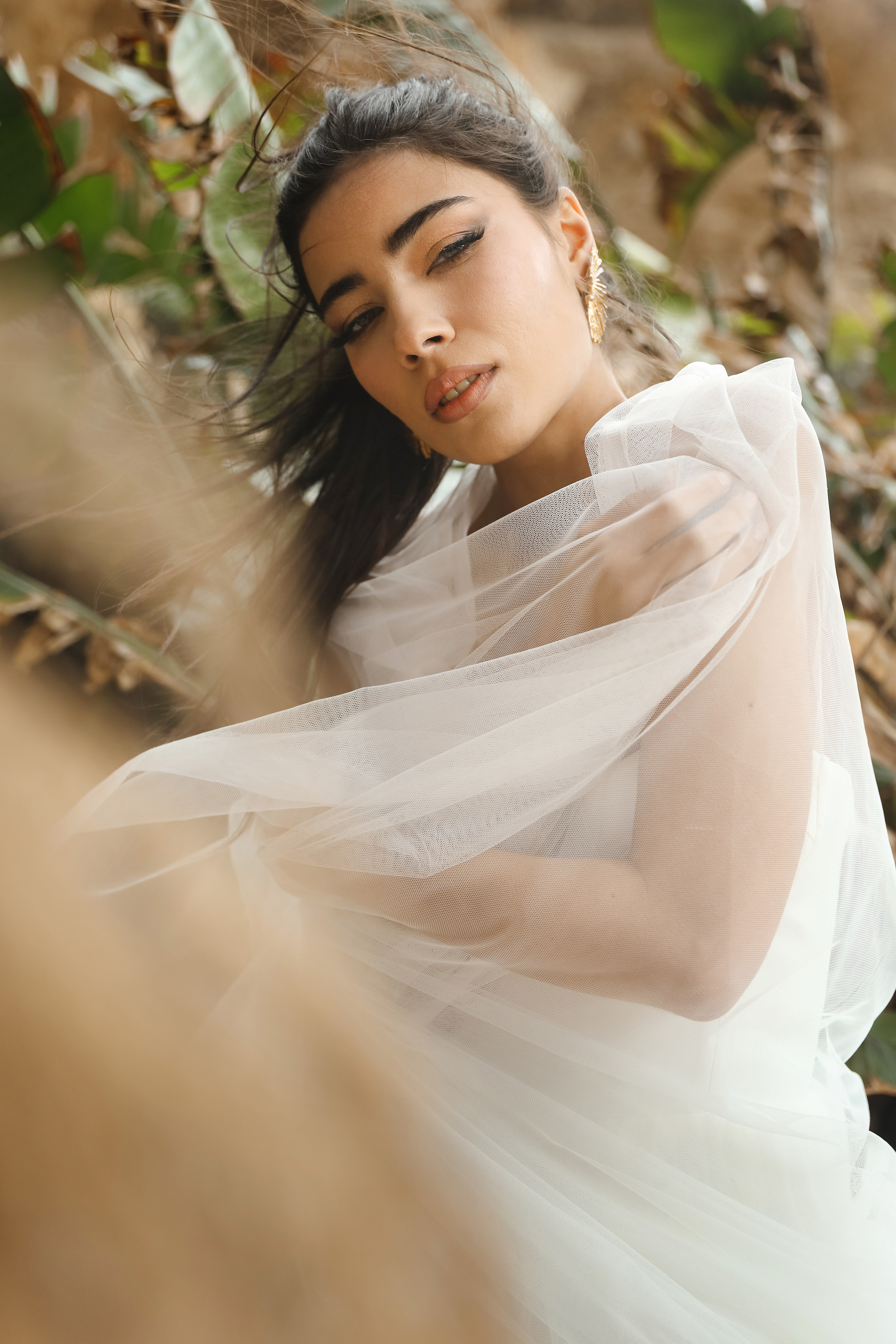 An art photo shoot of a girl in a wedding dress on the windy Kalithea beach in Rhodes, Greece
