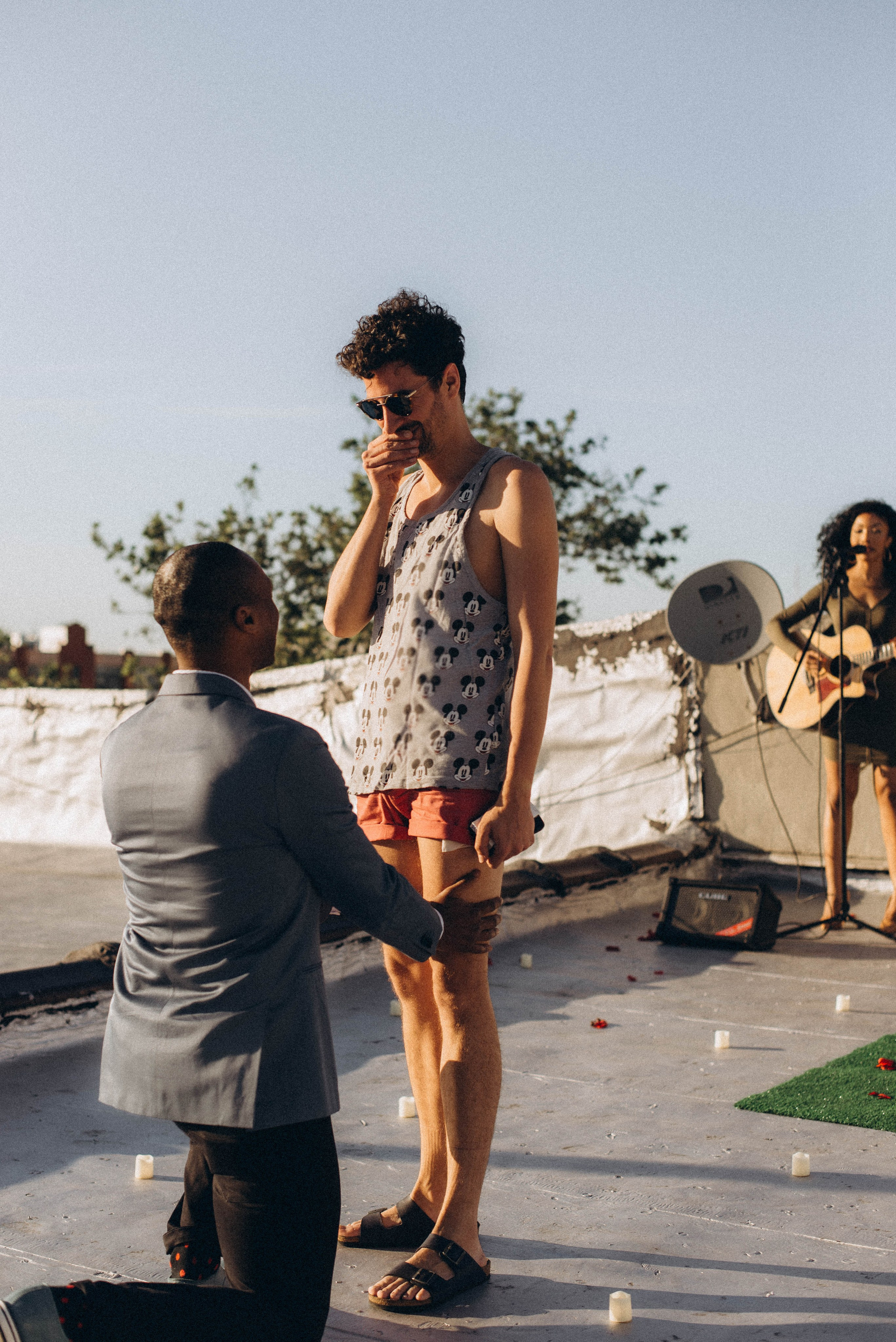 Proposal at Brooklyn Bridge Park with ferries passing.