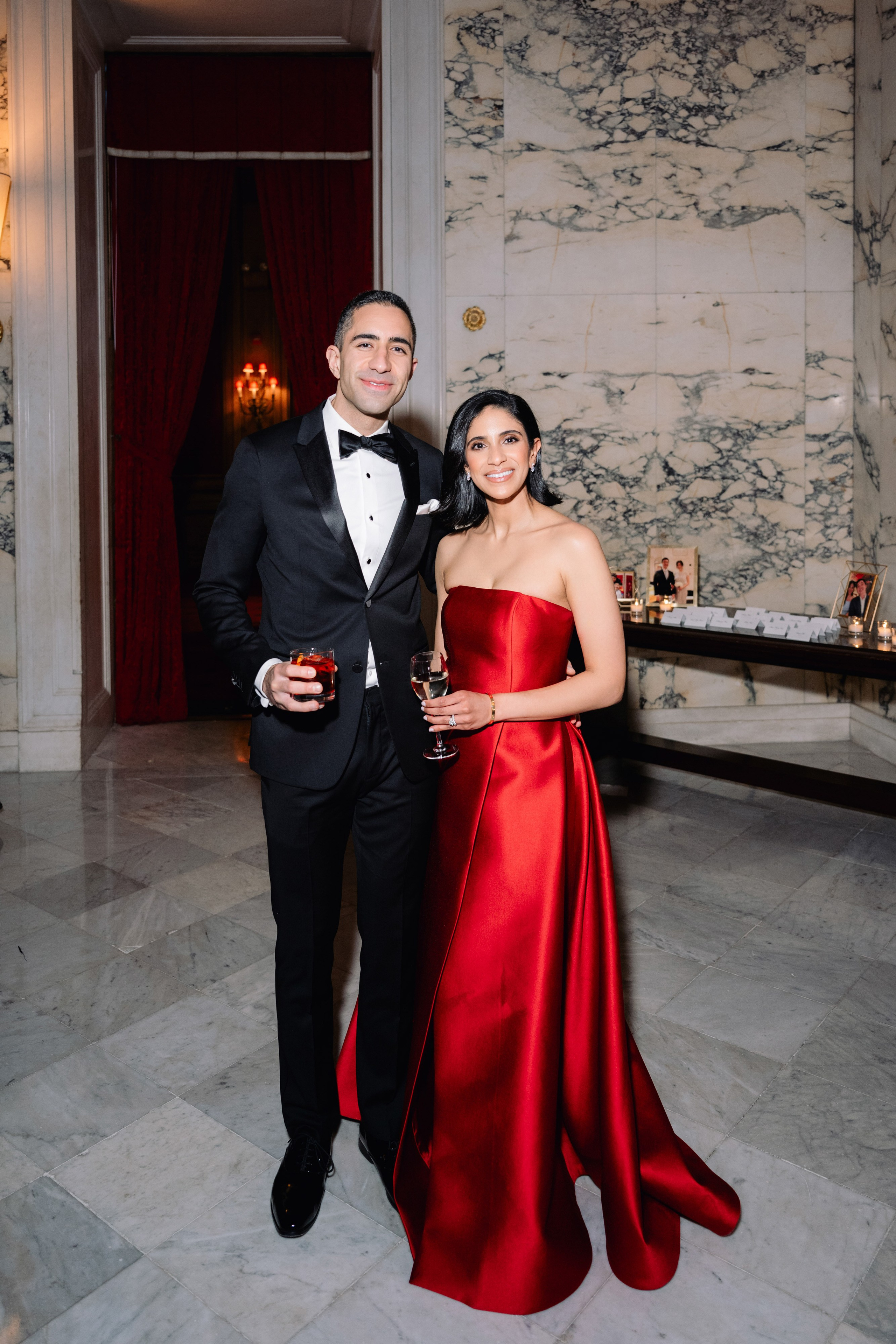 a man and woman in formal attire posing for a photo