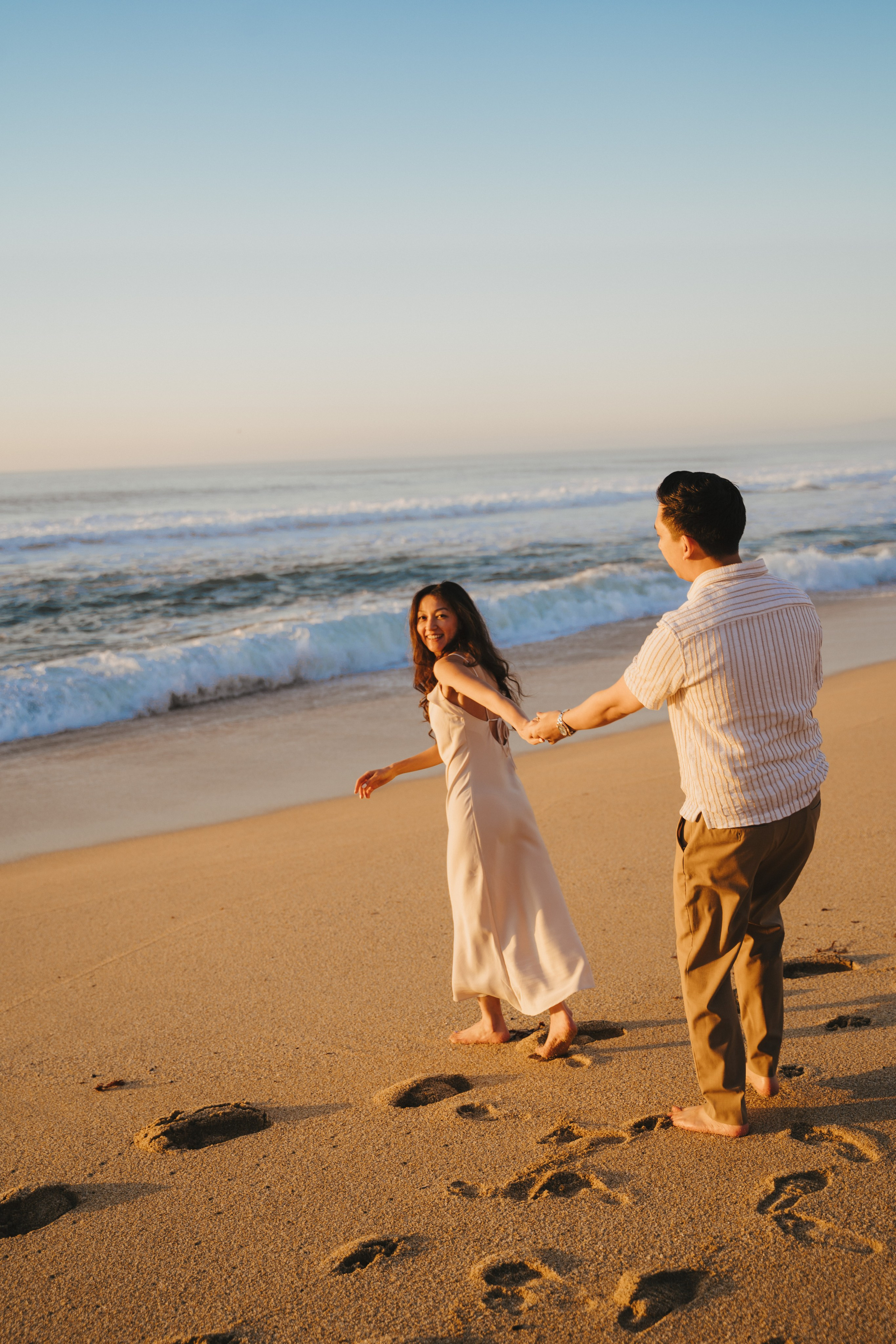 A photo shoot on the San Francisco beach at sunset. Engagement session. 