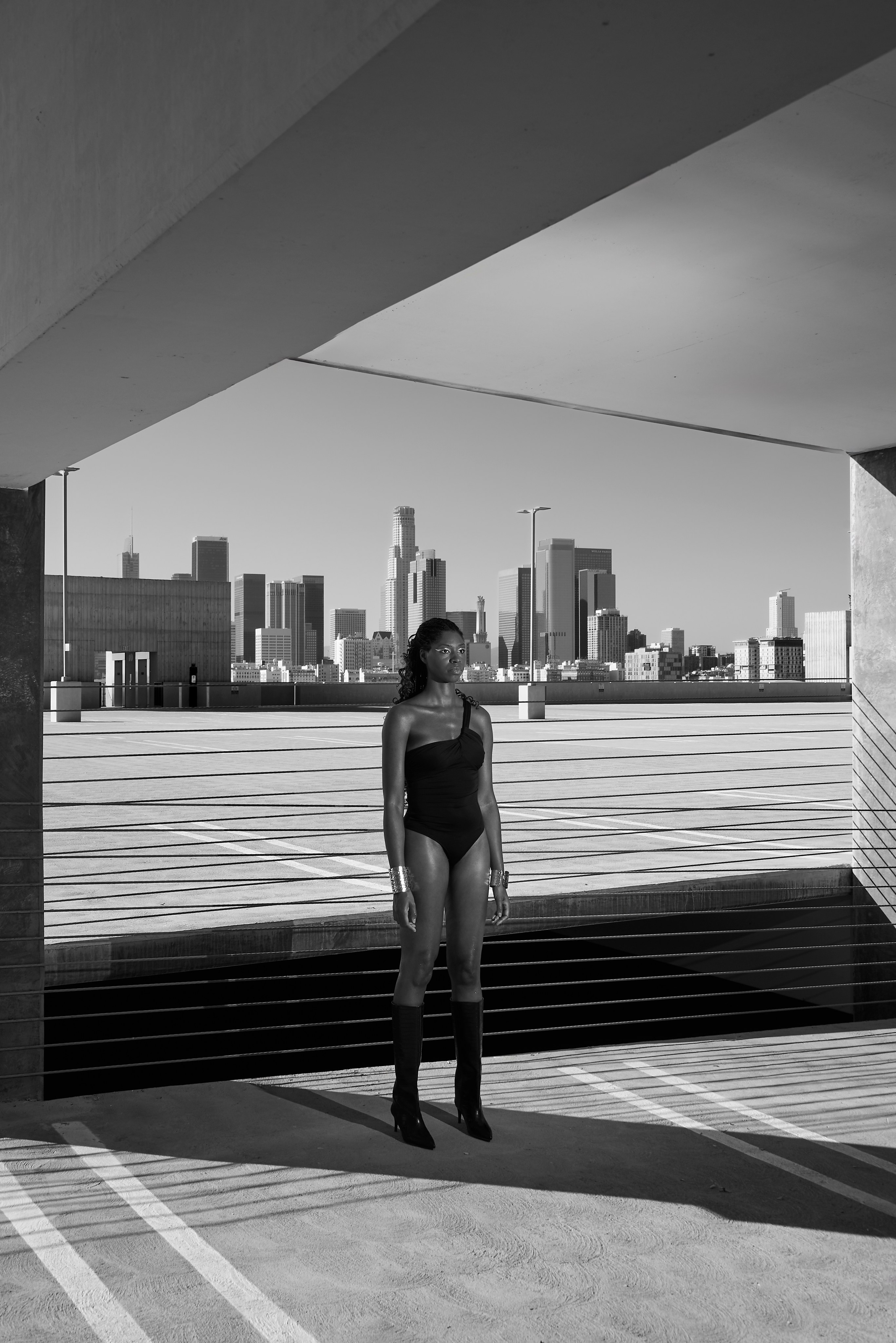 Model posing in a black bodysuit on a rooftop in Los Angeles