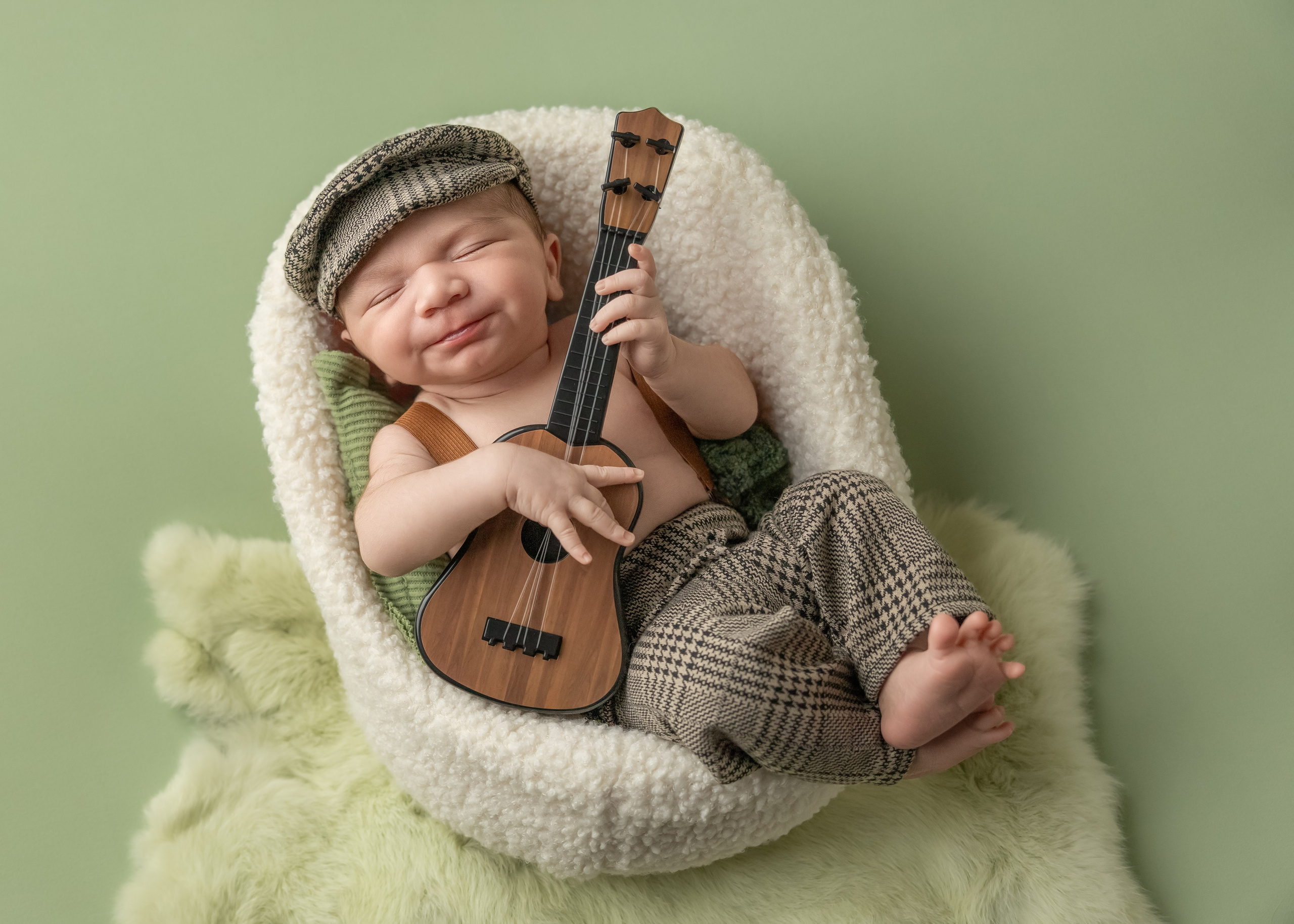 baby with guitar sitting in the armchair