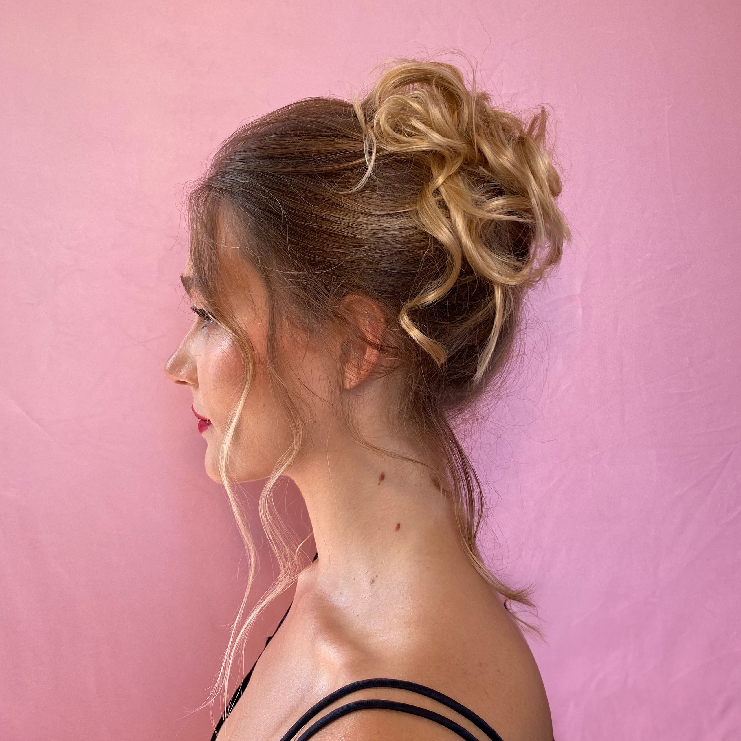 profile of a white girl with curly up-do hairstyle
