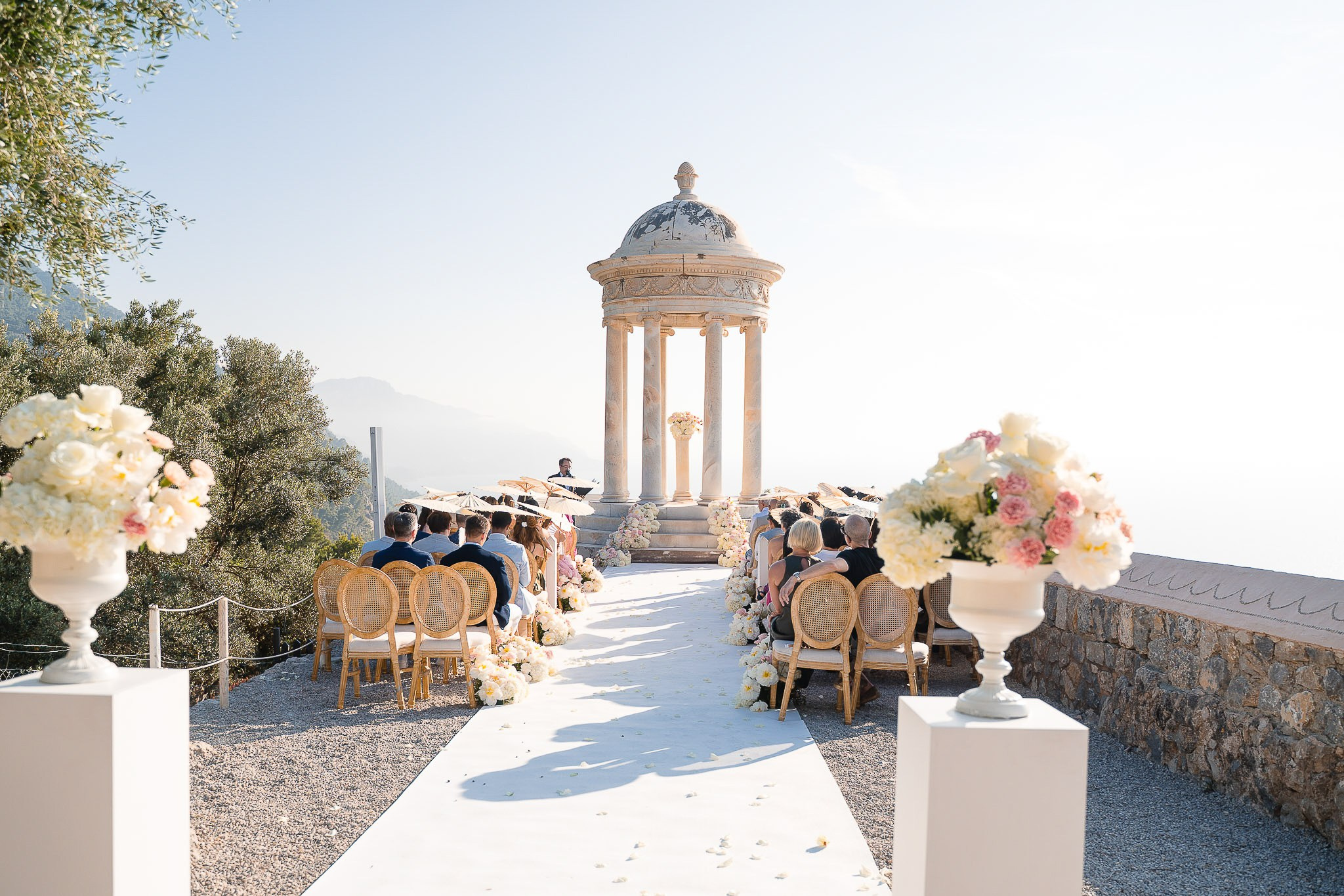 Guests seated under parasols at Son Marroig wedding ceremony