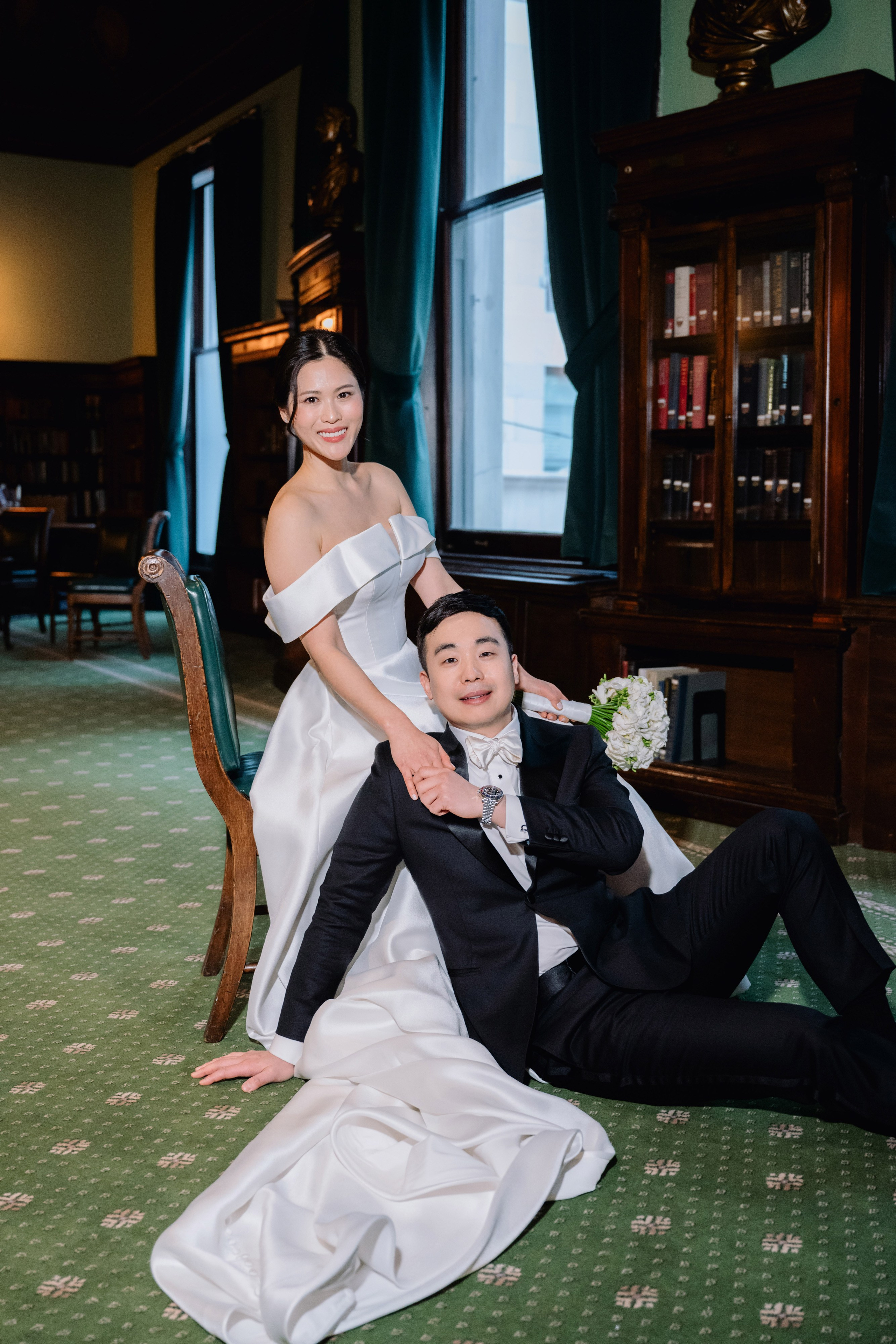 a bride and groom pose for a photo in a hotel