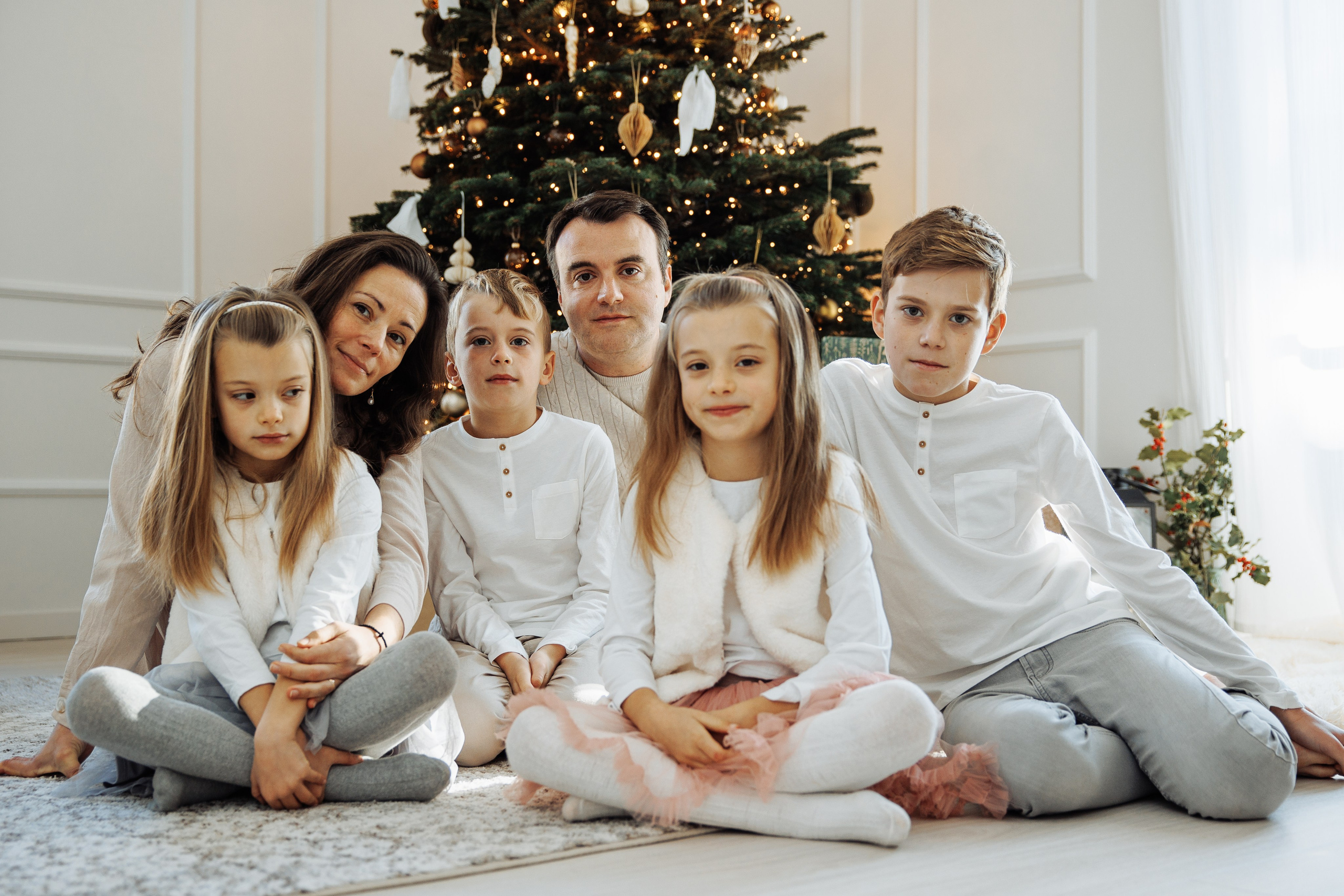 Family reunited in front of the Christmas tree, twins