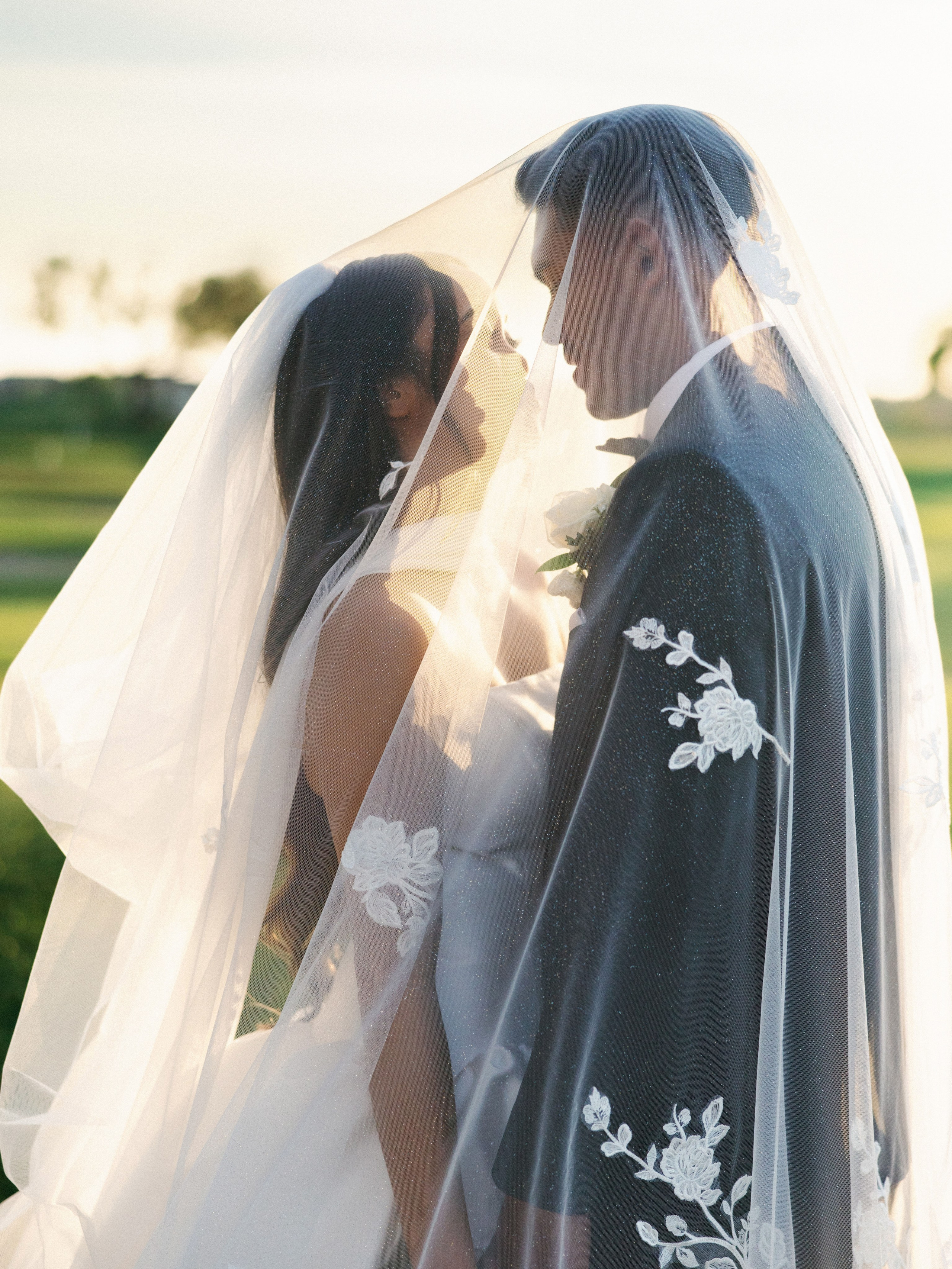 Bride and groom sharing an intimate portrait beneath her veil
