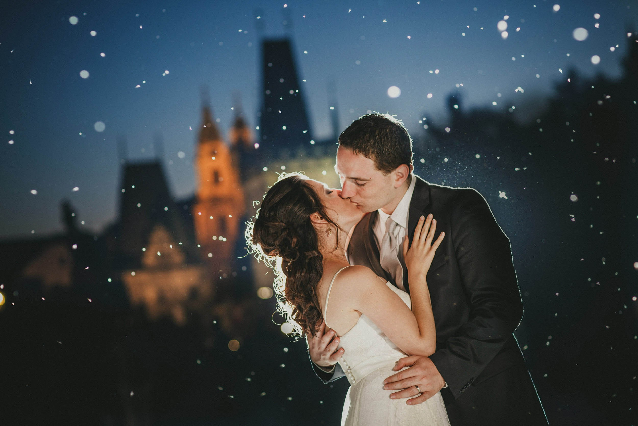 The atmospheric Charles Bridg provides the romantic background for an Israeli bride & groom who share a sexy kiss surrounded by glowing insects that cast a magical spell.
