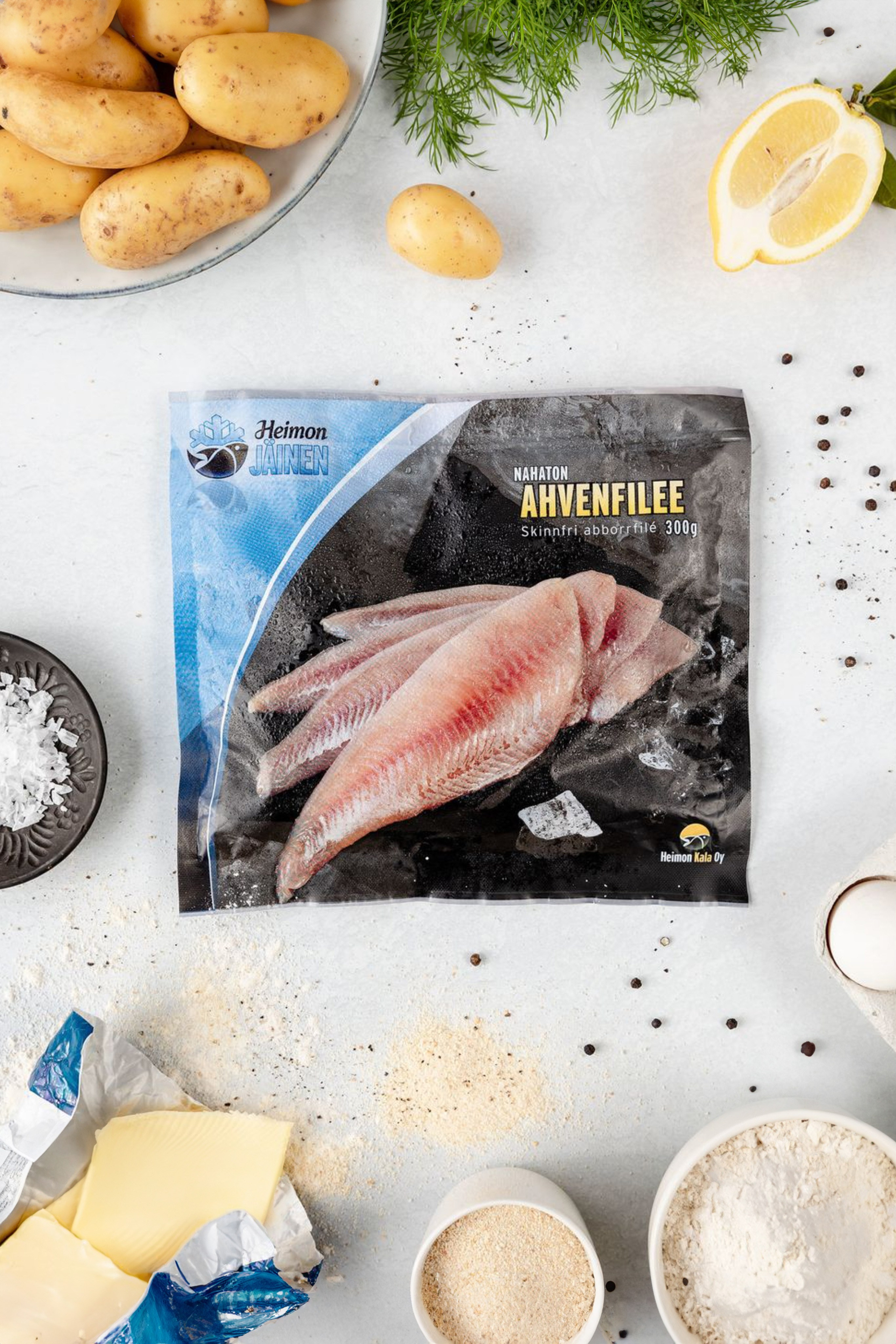 Package of frozen fish filee with uncooked potatoes, flour and butter. Product photography for a brand with ingredients.