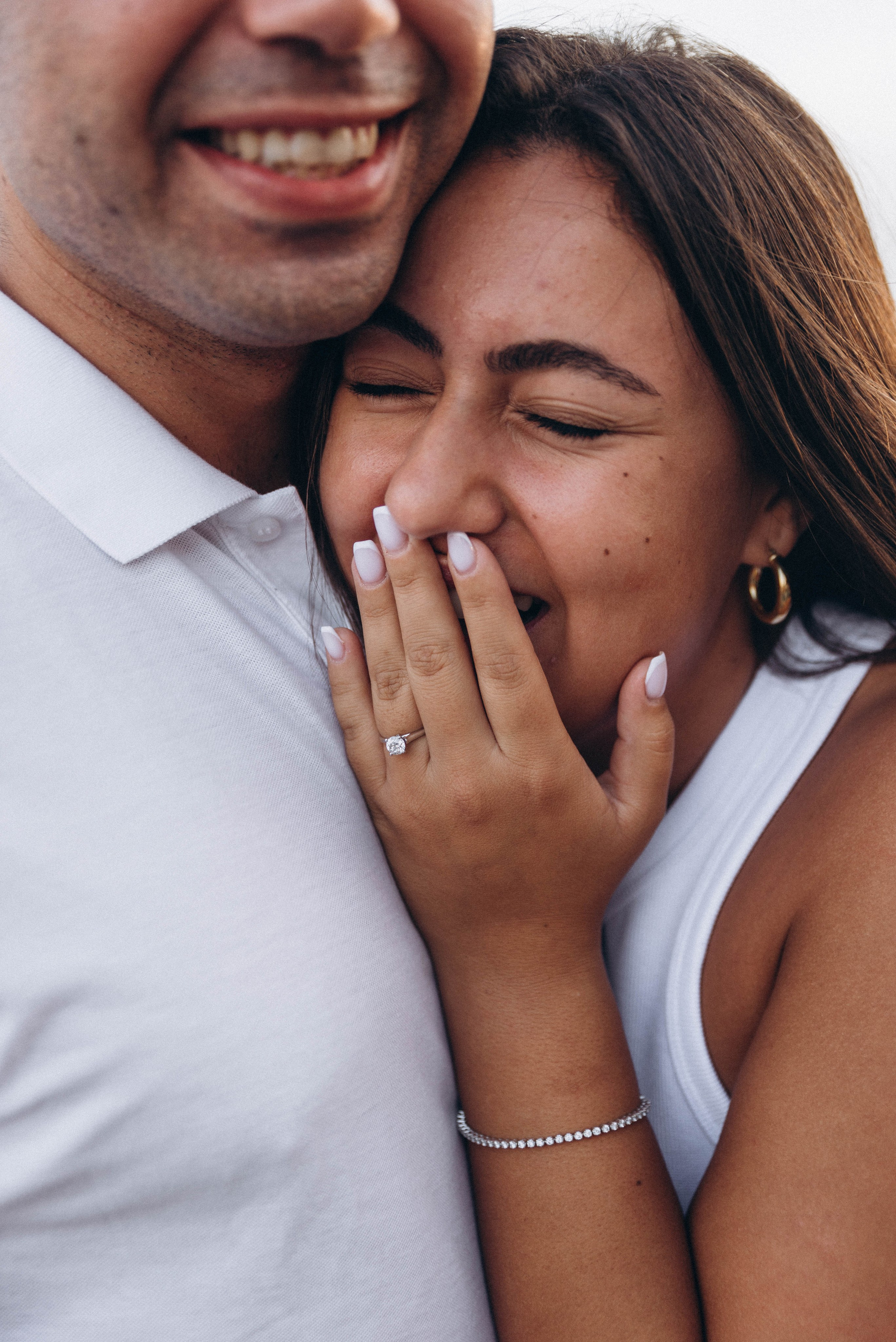 Bride-to-be smiling during proposal at Central Park fountain.