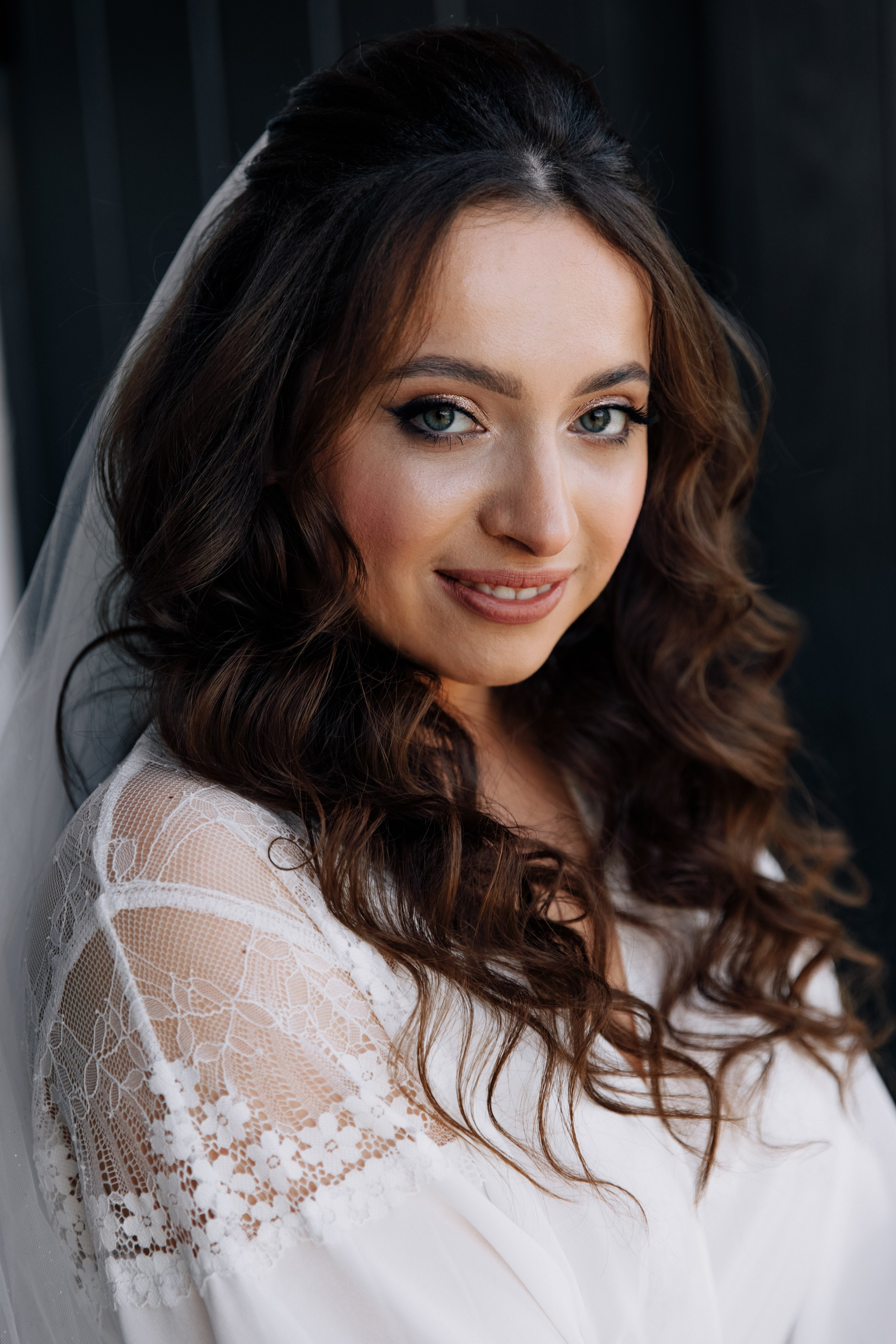 Die Braut lächelt in die Kamera. Ein fröhlicher und glücklicher Moment während der Hochzeitsvorbereitungen.