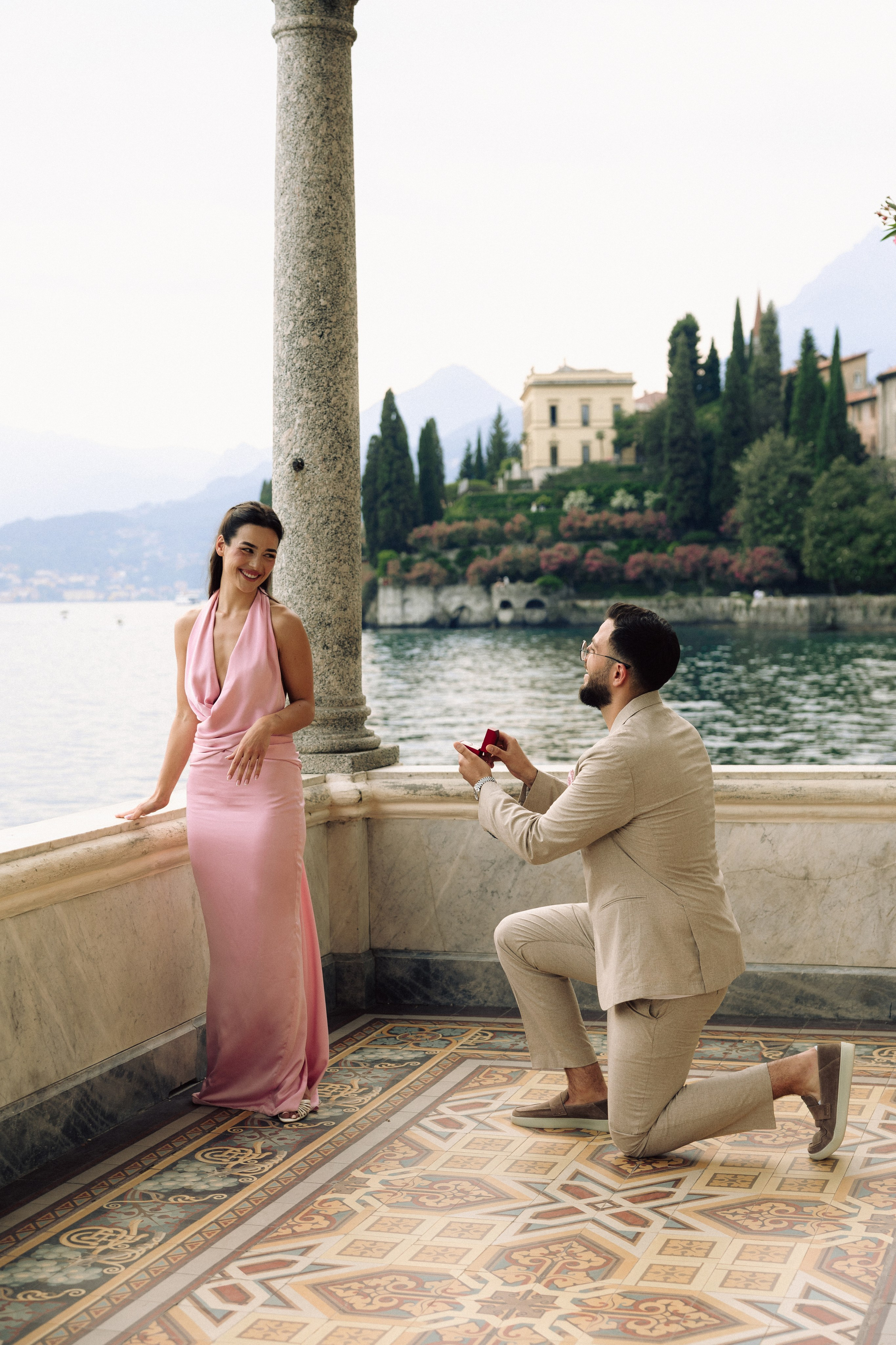 Man proposing to his girlfriend on one knee during a Lake Como proposal