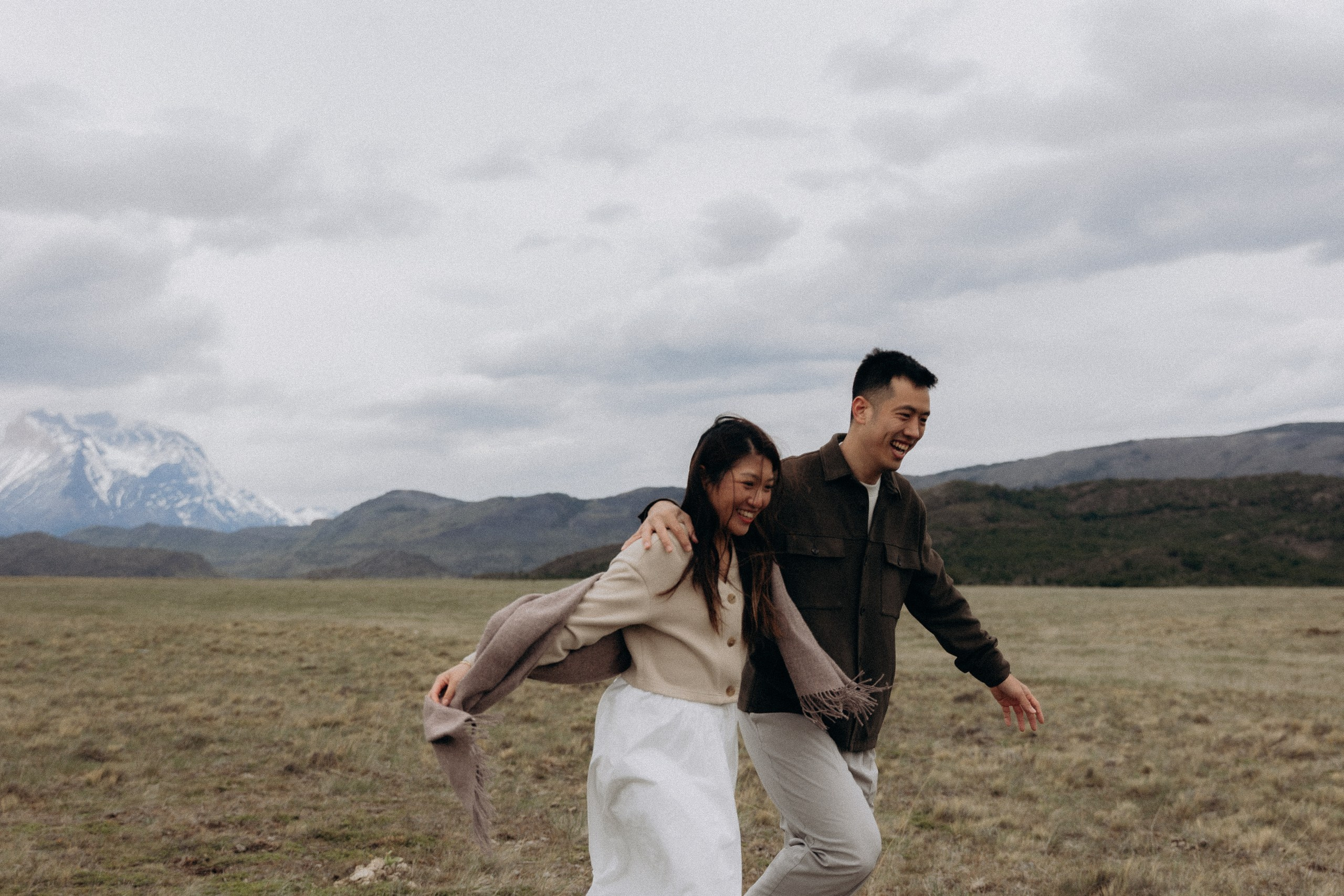 Couple running across the Patagonian steppe
