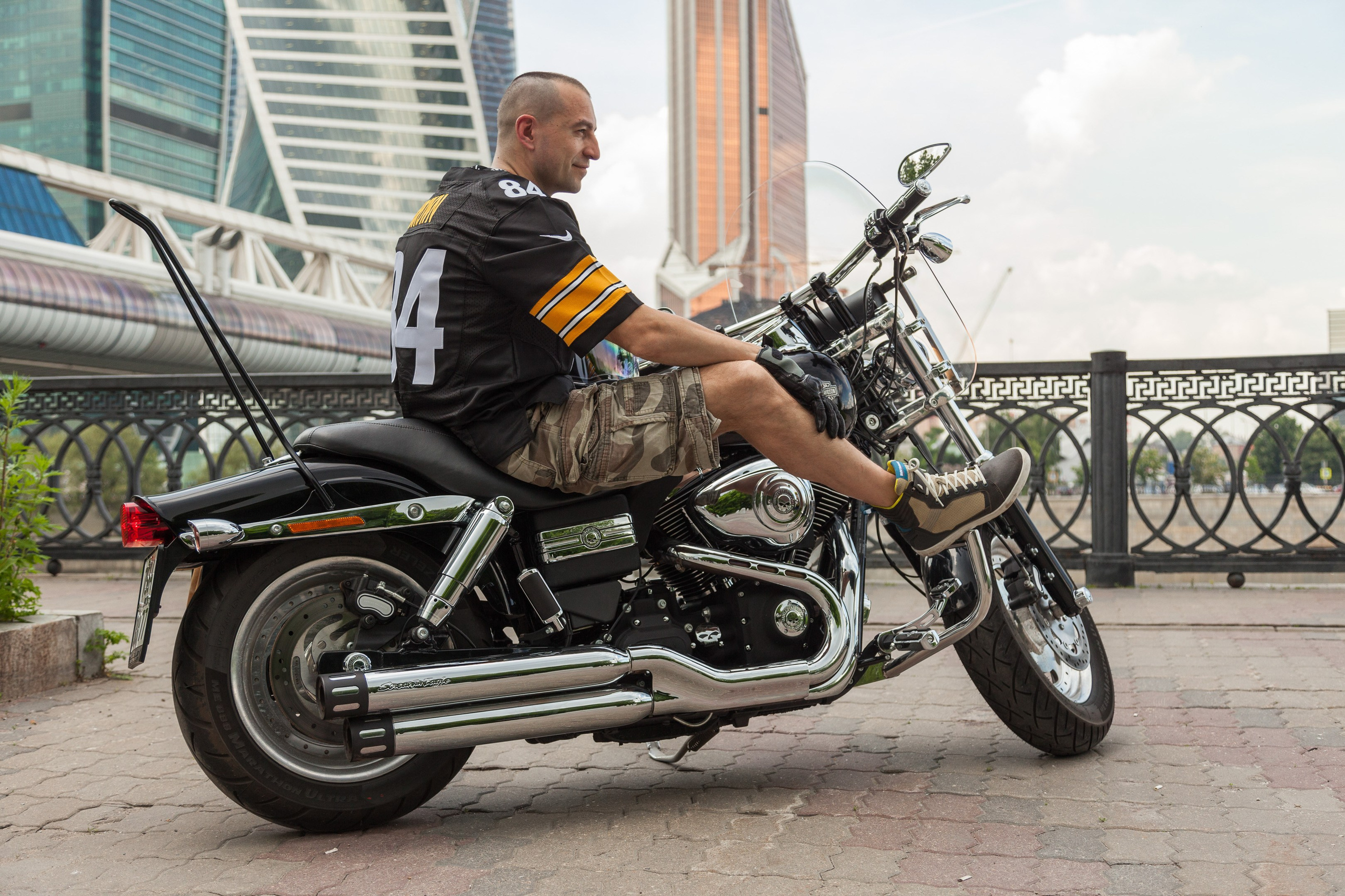 Location portrait of a biker on a Harley Davidson motorcycle in city landscape - photographer Andrey Dunin