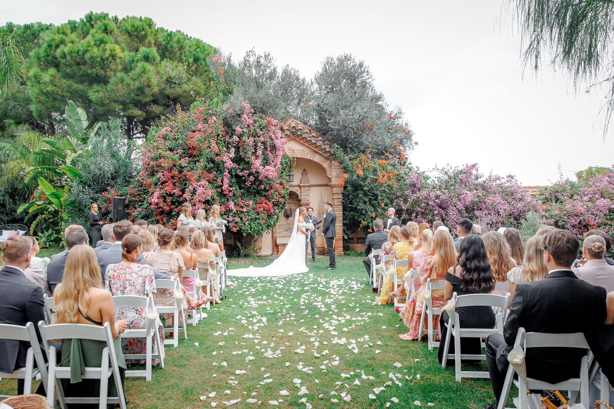 Ceremony setup at a historic wedding venue in Barcelona, showcasing charming architecture and floral arrangements.