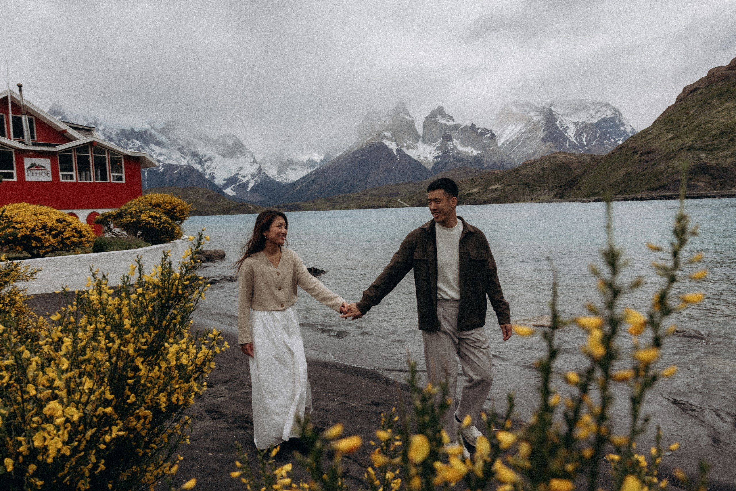 Couple walking beside a lake in Torres del Paine