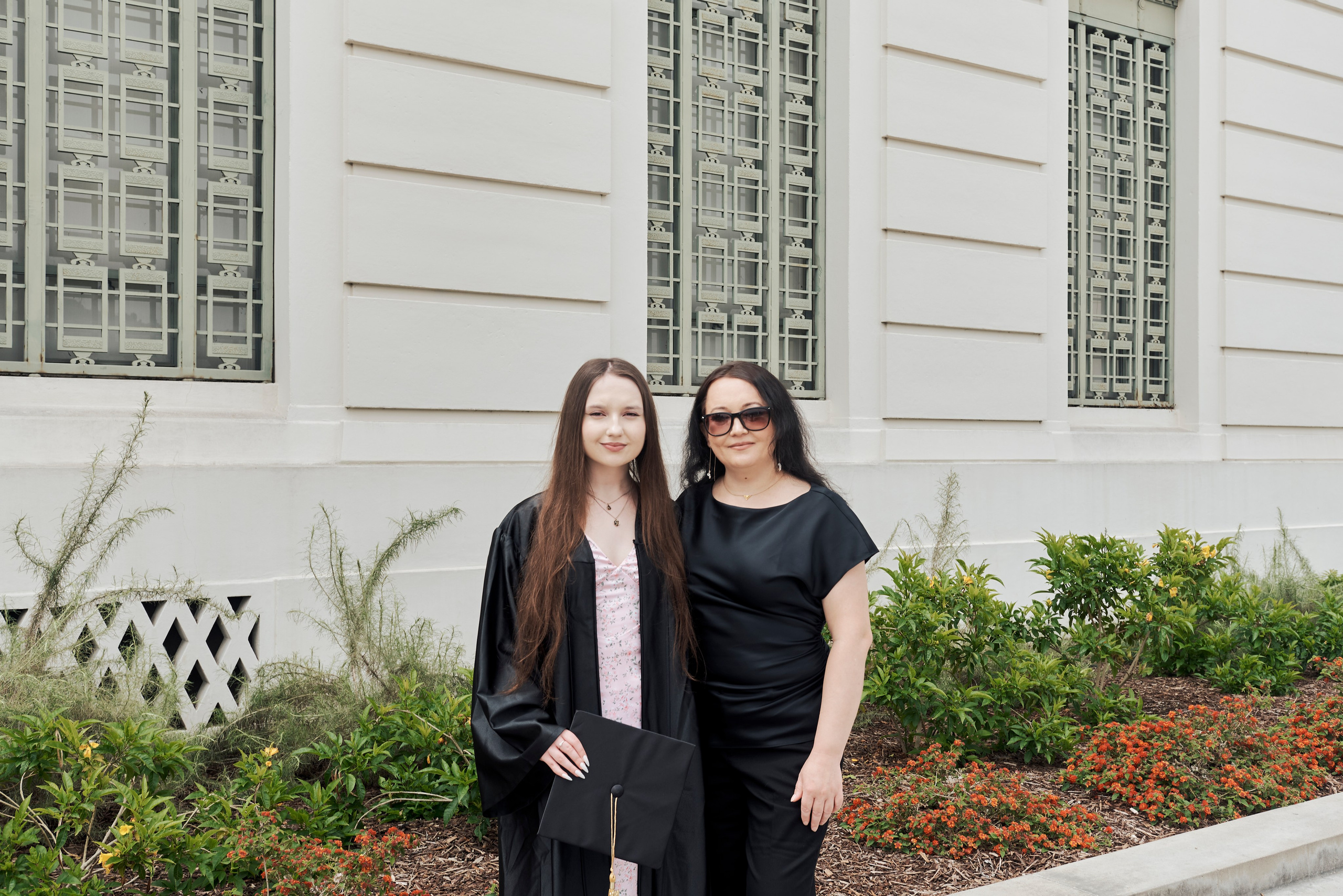 Fun graduation photo of a student jumping with joy at a Los Angeles university campus
