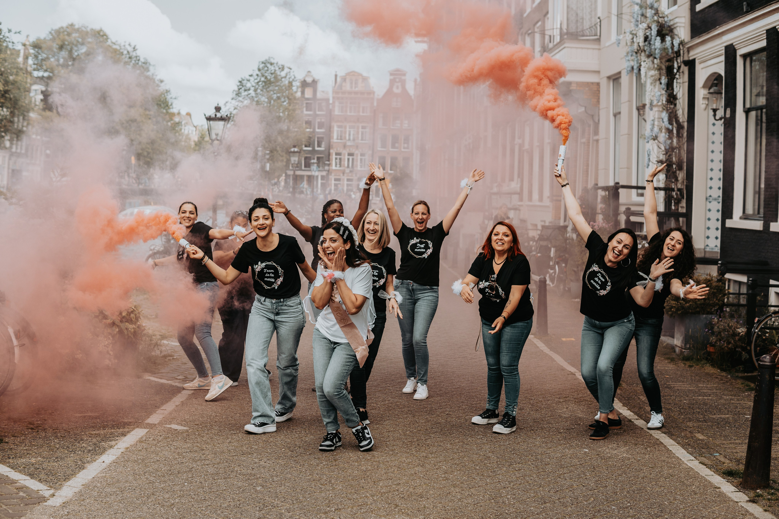 girls popping color smokes in a bachelorette party
