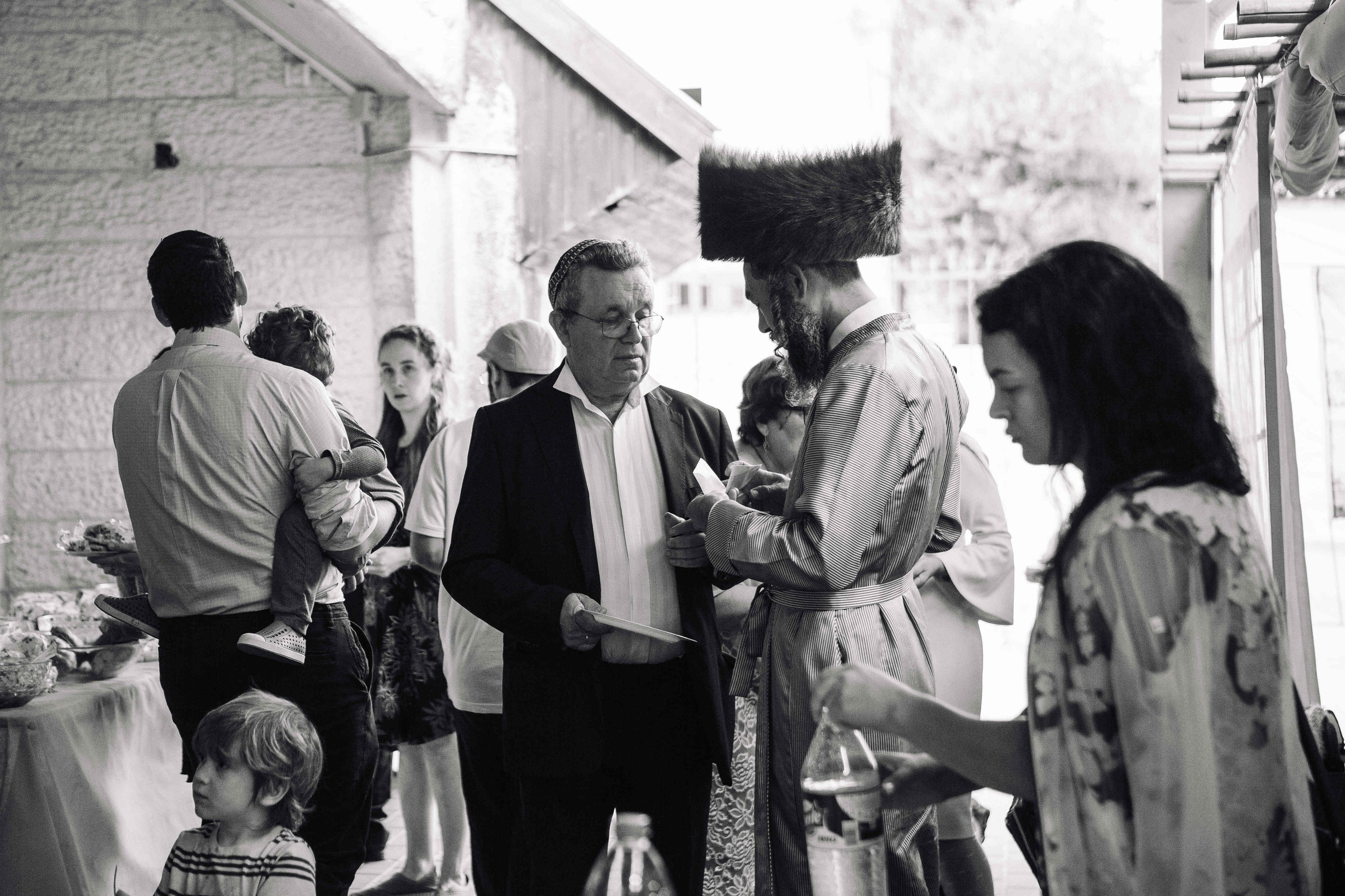 BRITH MILA IN THE SMALL SYNAGOGUE. PHOTOGRAPHER IN ISRAEL
