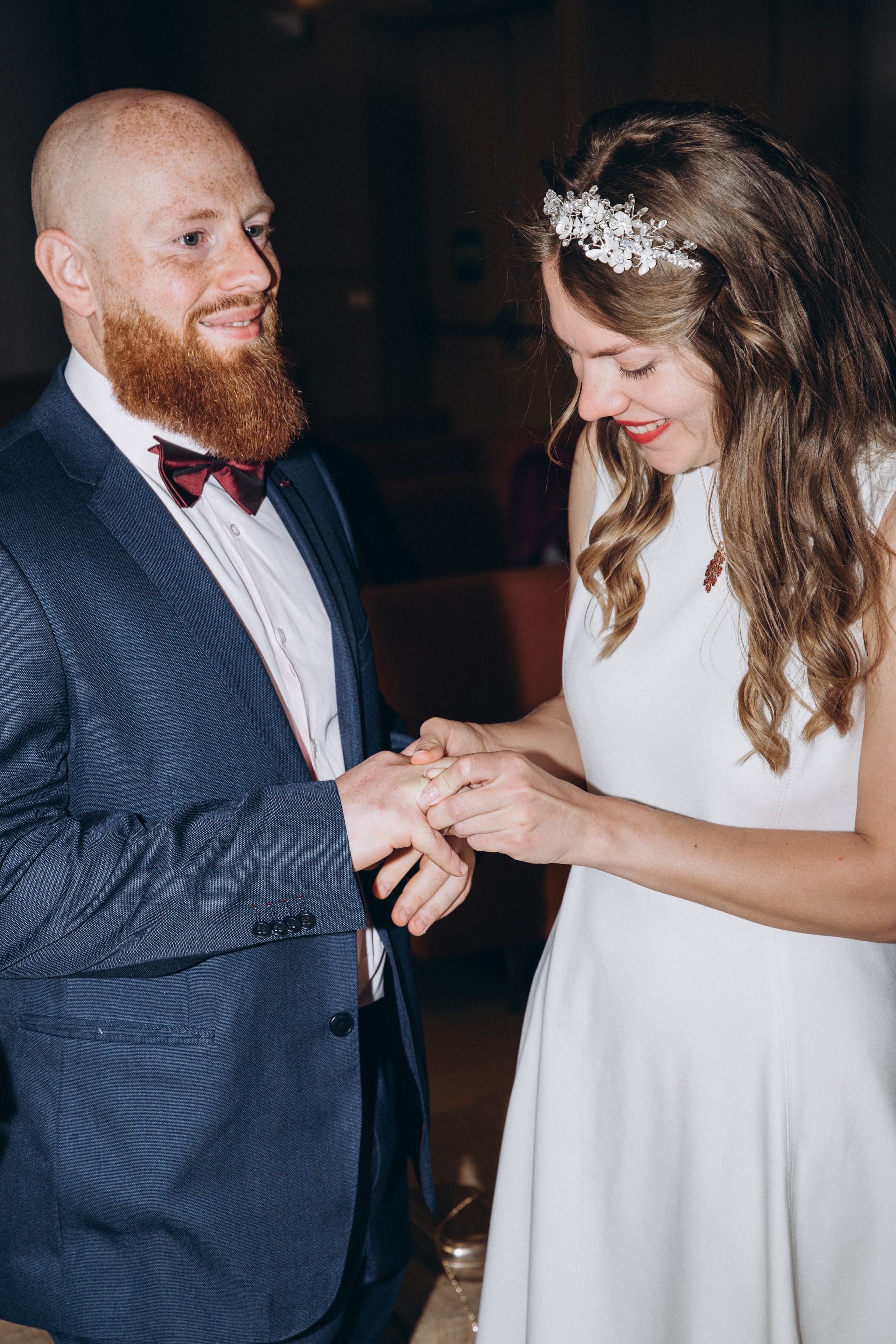 Emotional wedding ring exchange during an intimate ceremony in Madrid, Spain — radiant bride in a white dress places a ring on the groom’s finger, capturing a timeless and heartfelt moment. Ideal inspiration for romantic wedding photoshoots in Madrid and across Spain.