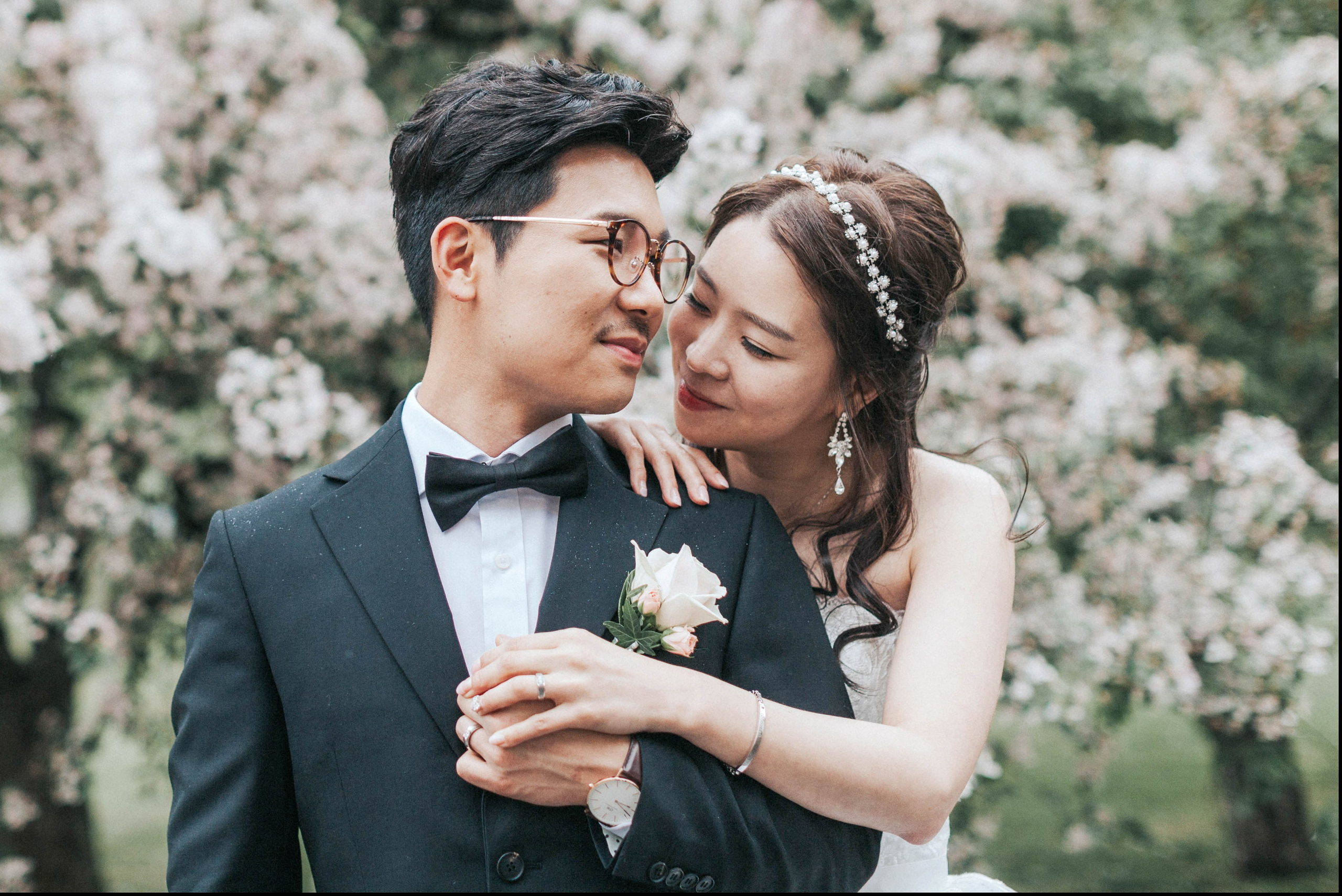 Korean groom caressed by bride in the rain, Prague destination wedding