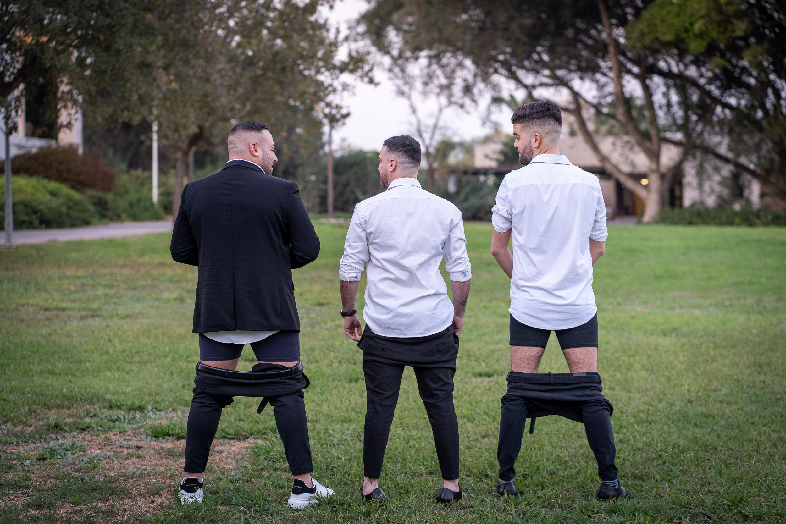 Groom and groomsmen having a funny and candid moment during a wedding photo session in Israel