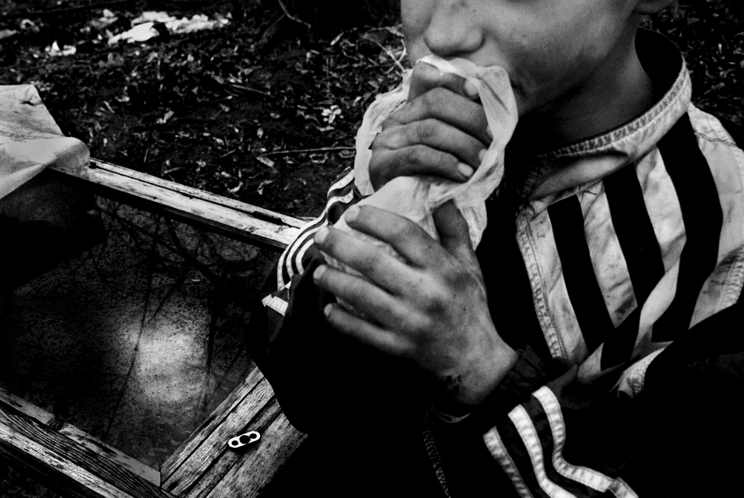 Denise Selivanov, 13, inhales glue while his younger brother Artyom, 9, watches from a box the children use to get high in. After suffering years of abuse at the hands of their alcoholic father, Denise made the decision that life on the streets would be far easier than the misery they experienced at home. 'I wanted something better for my brother, but it looks like I messed up.' 