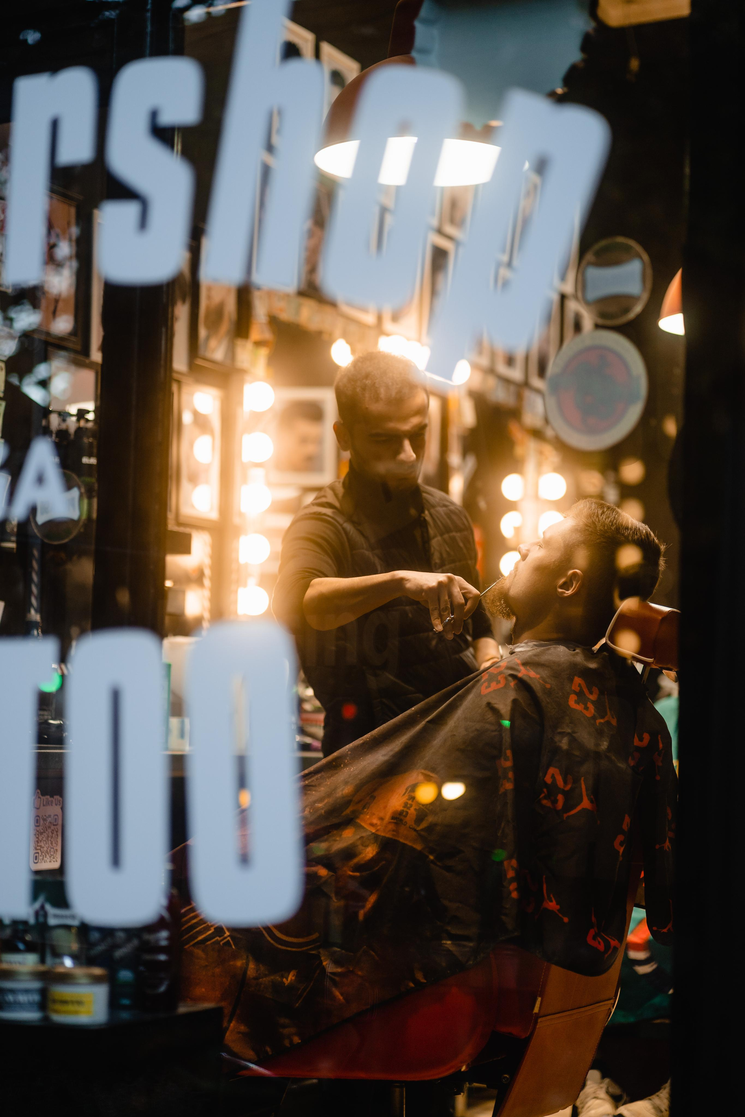 Neon-lit signage reflected on a glass window, creating a vibrant and abstract visual.