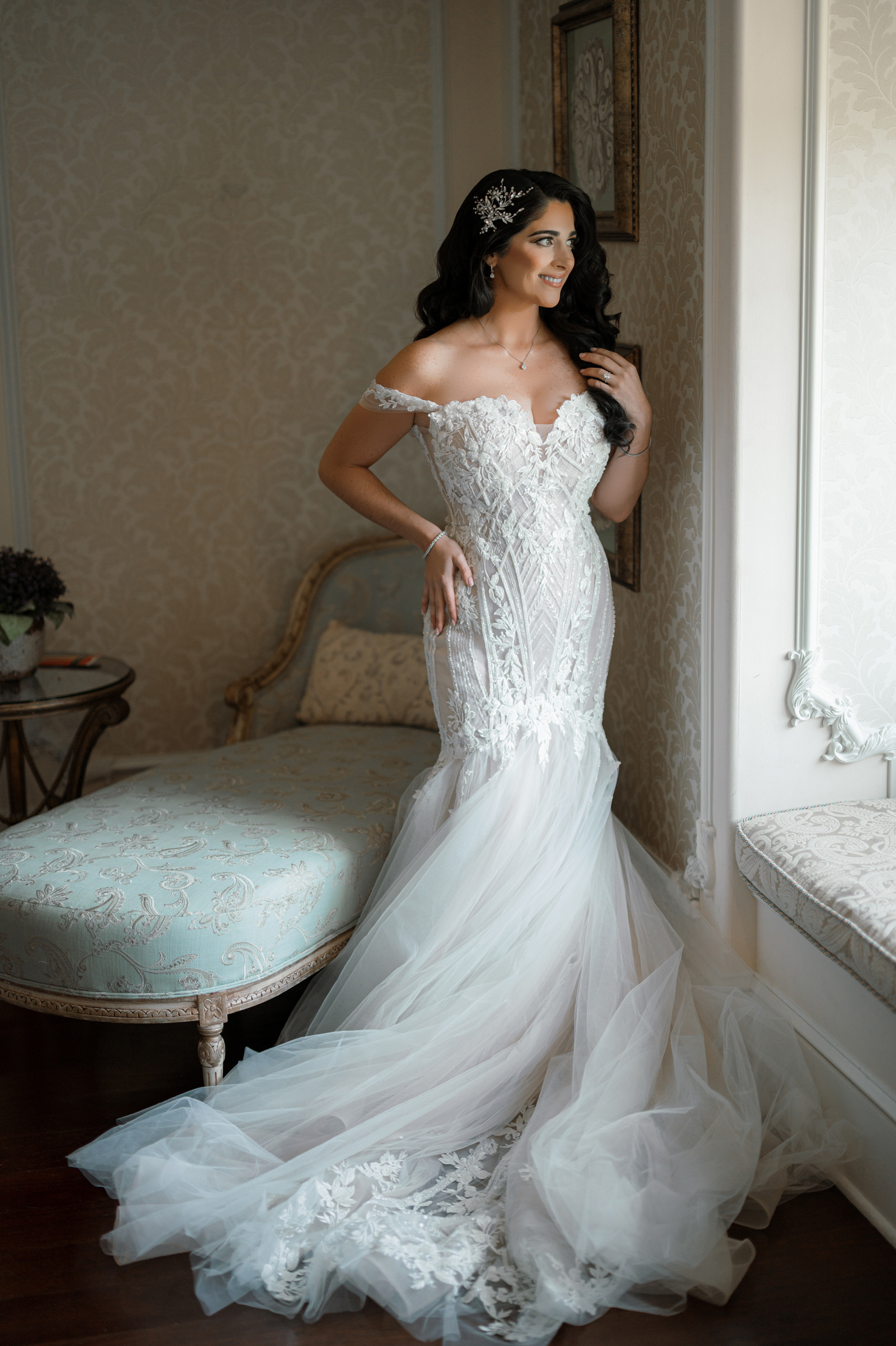 a woman in a wedding dress standing in front of a mirror