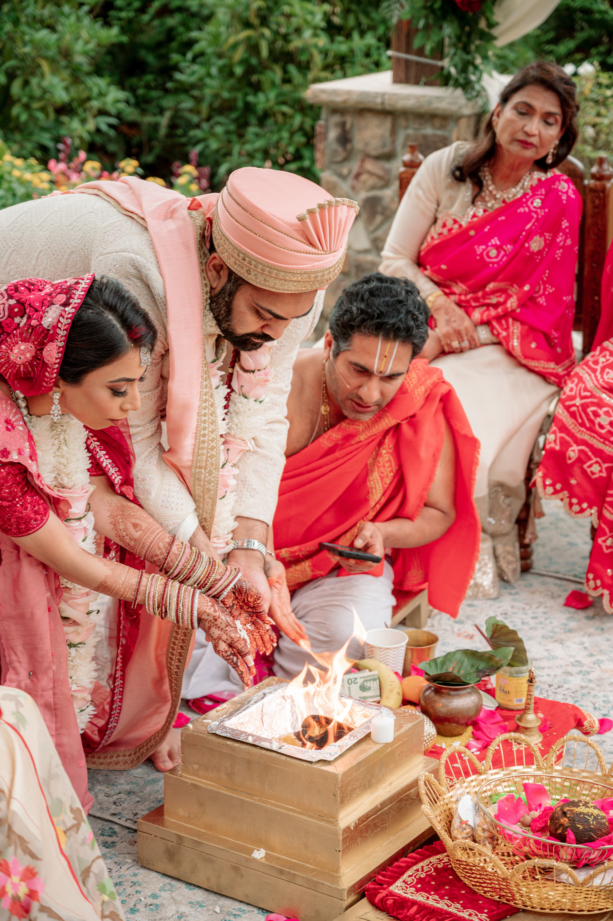 a group of people sitting around a cake