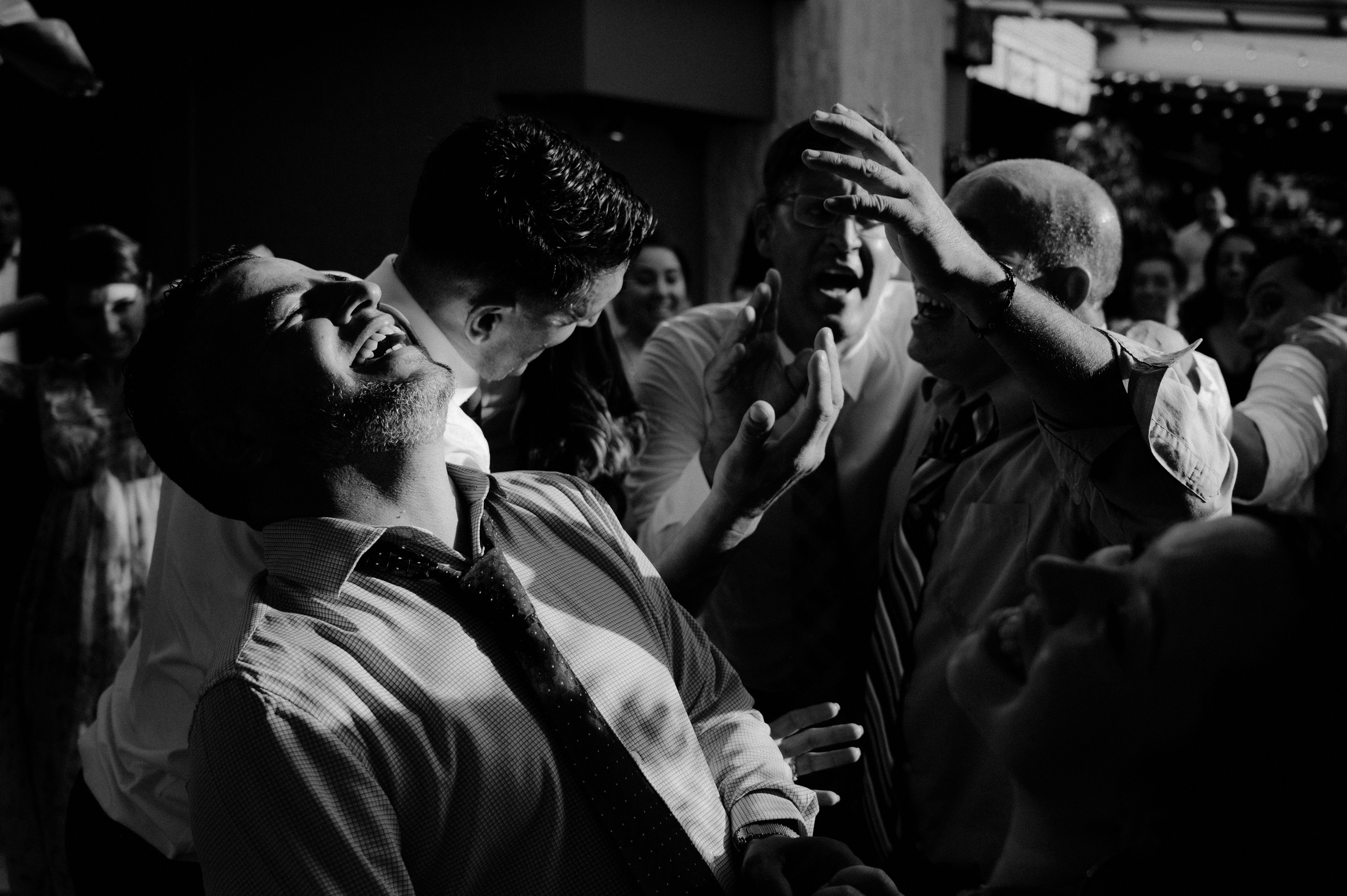 a man in a tie is dancing with other people