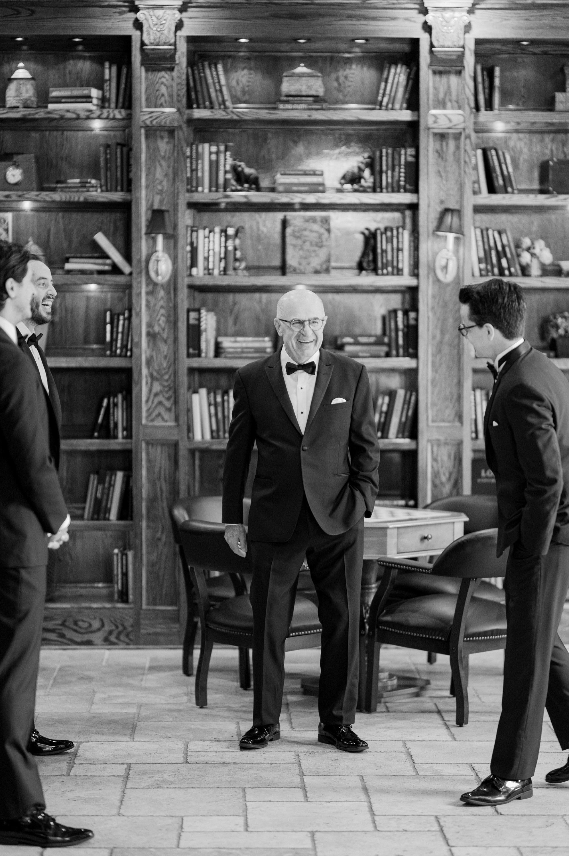 a group of men in suits and ties standing in a room