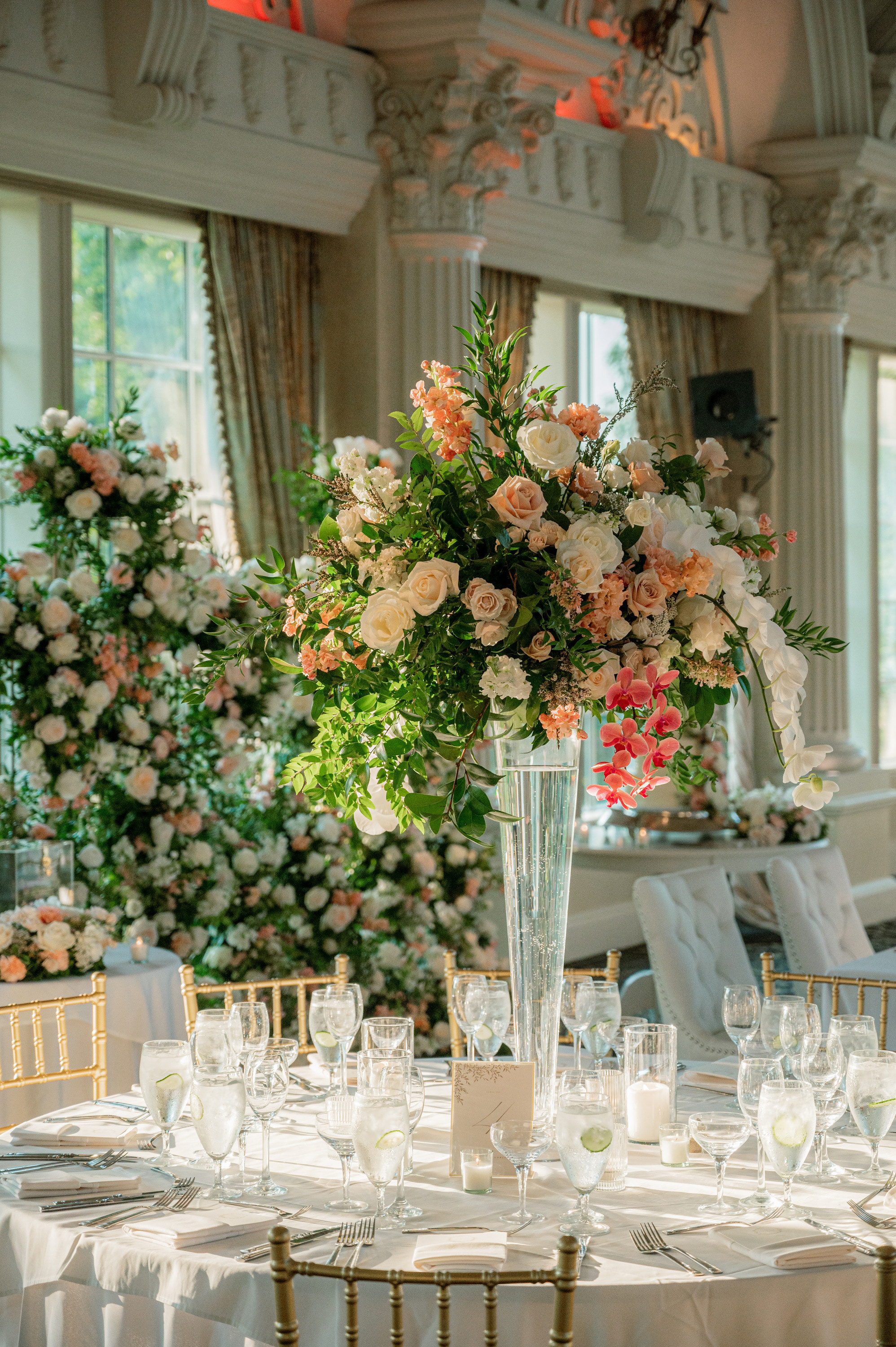 a table with a vase of flowers and candles