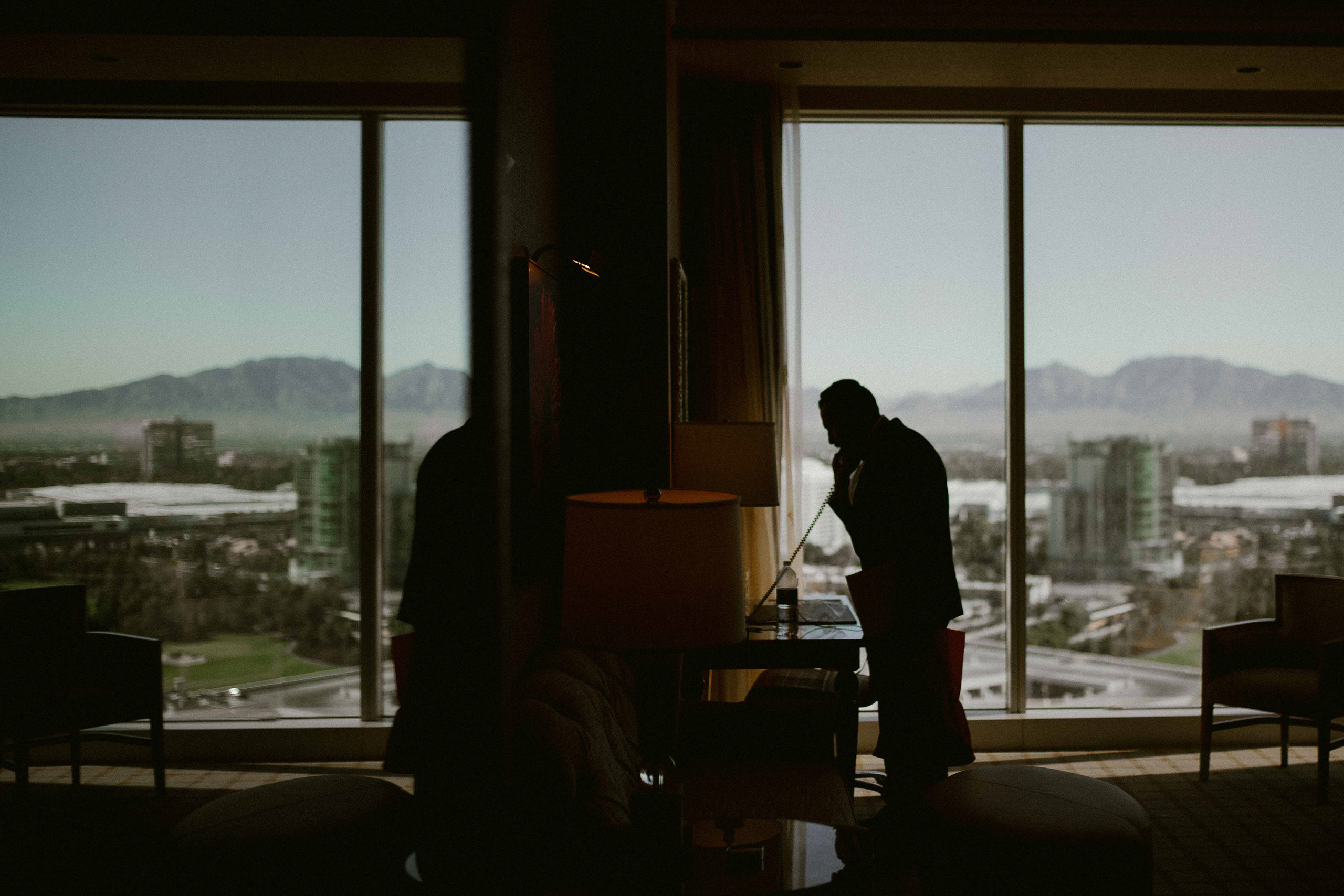 a man standing in front of a window looking out