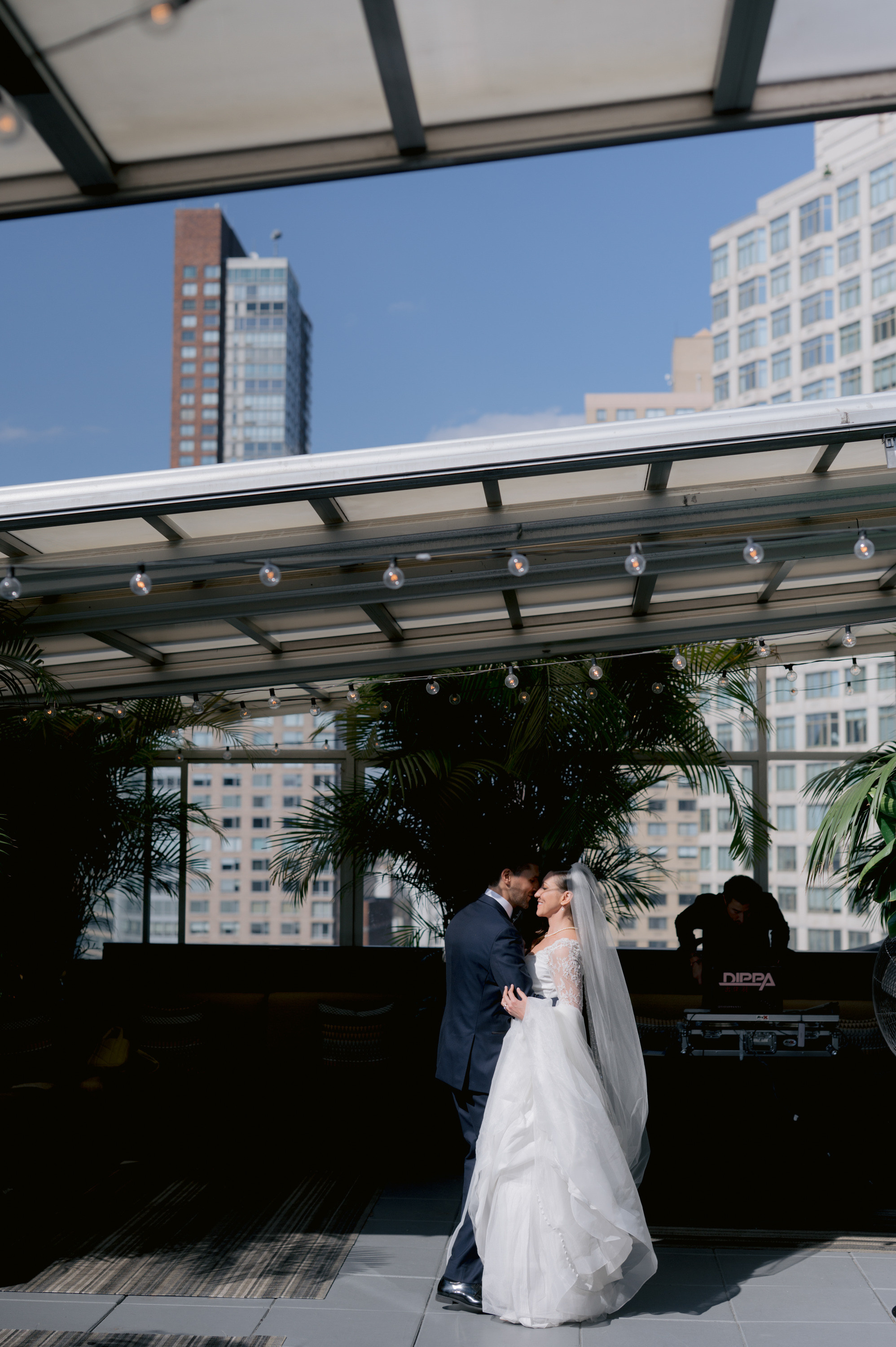 a bride and groom kissing in front of a building