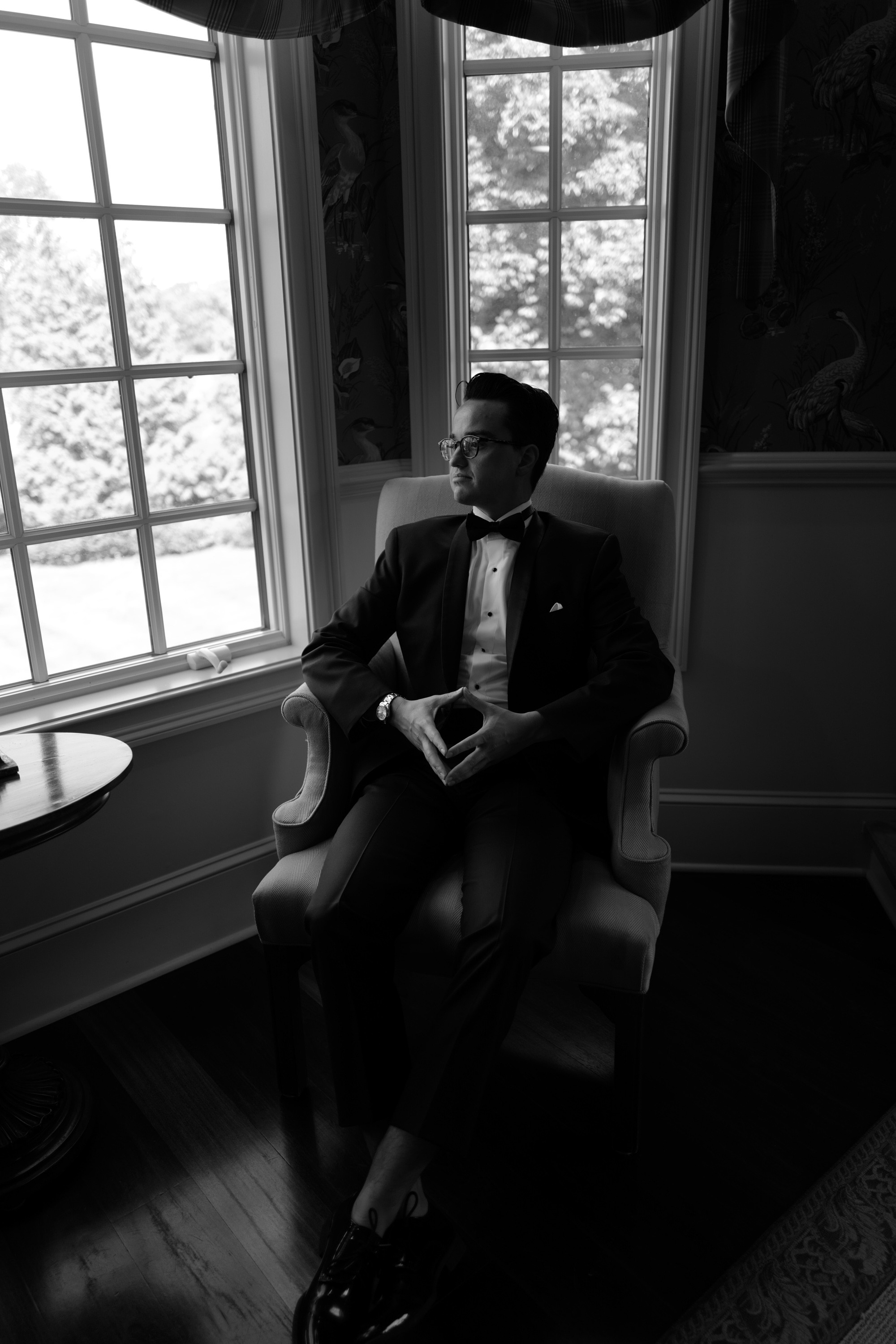 a man in a suit sitting in a chair