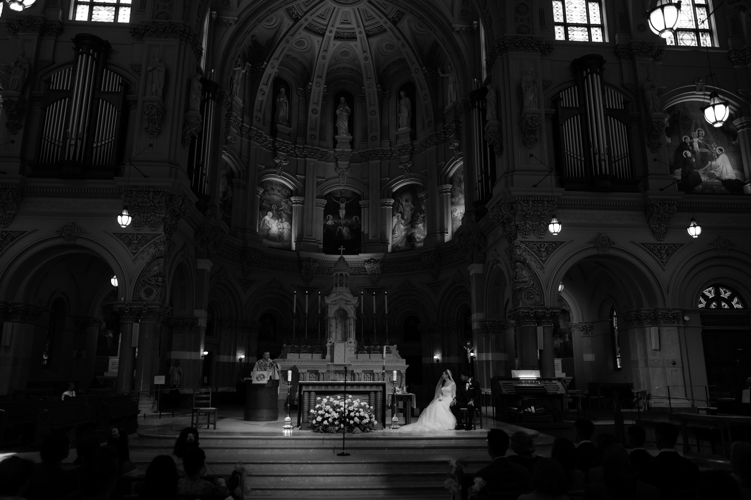 a bride and groom are sitting in the pew at the alter