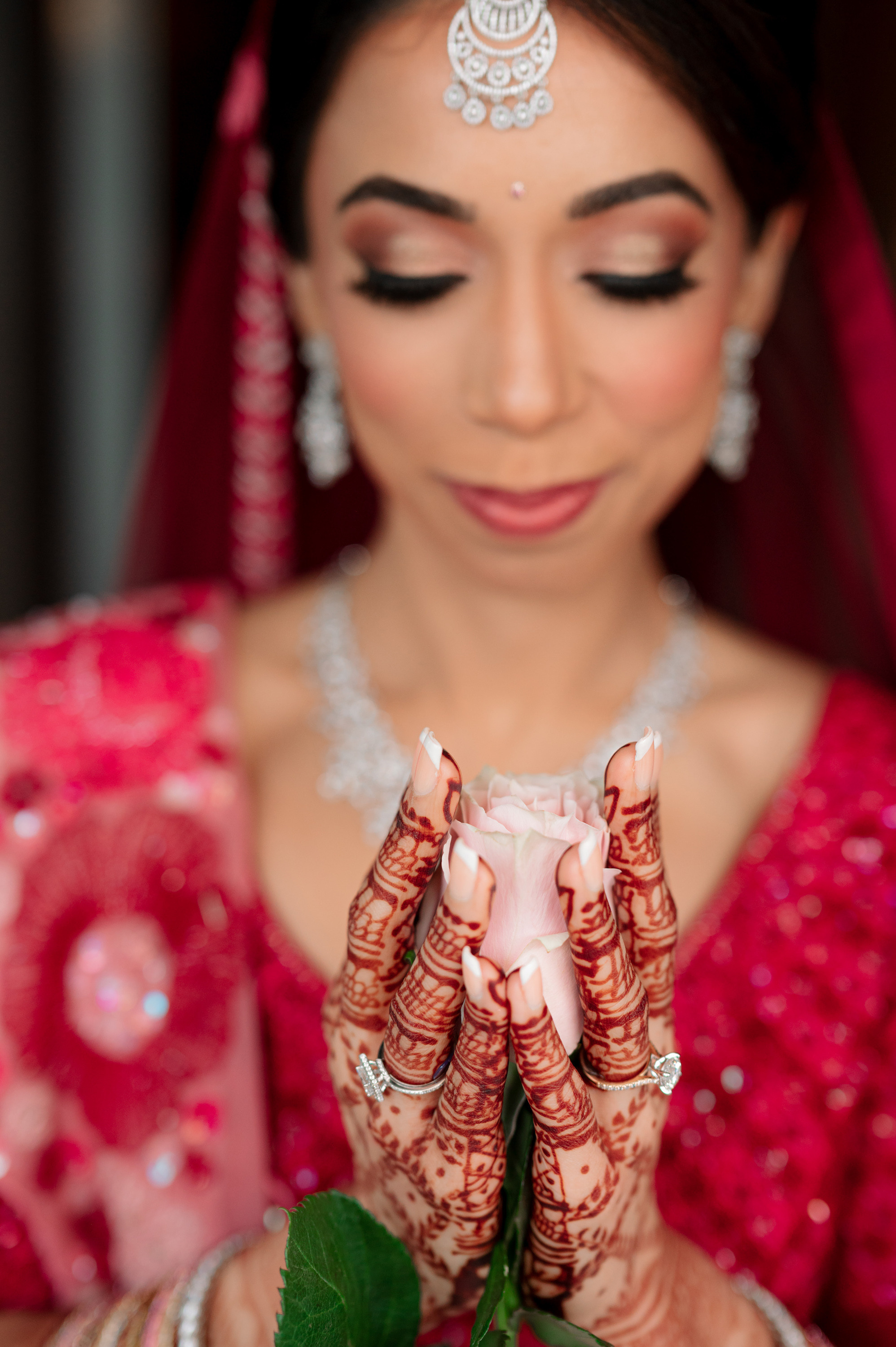 a bride holding a flower in her hands