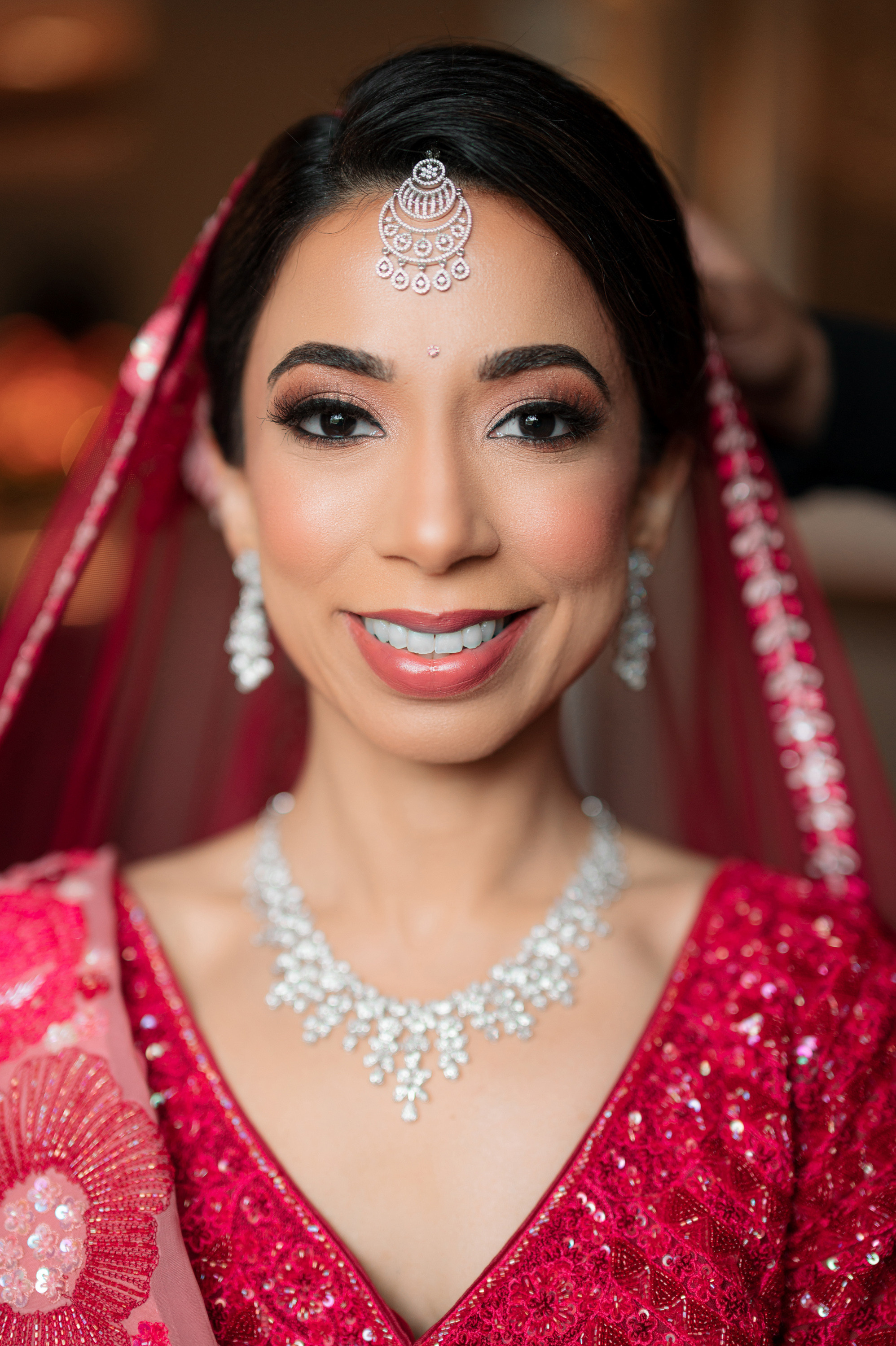 a bride in a red dress and veil