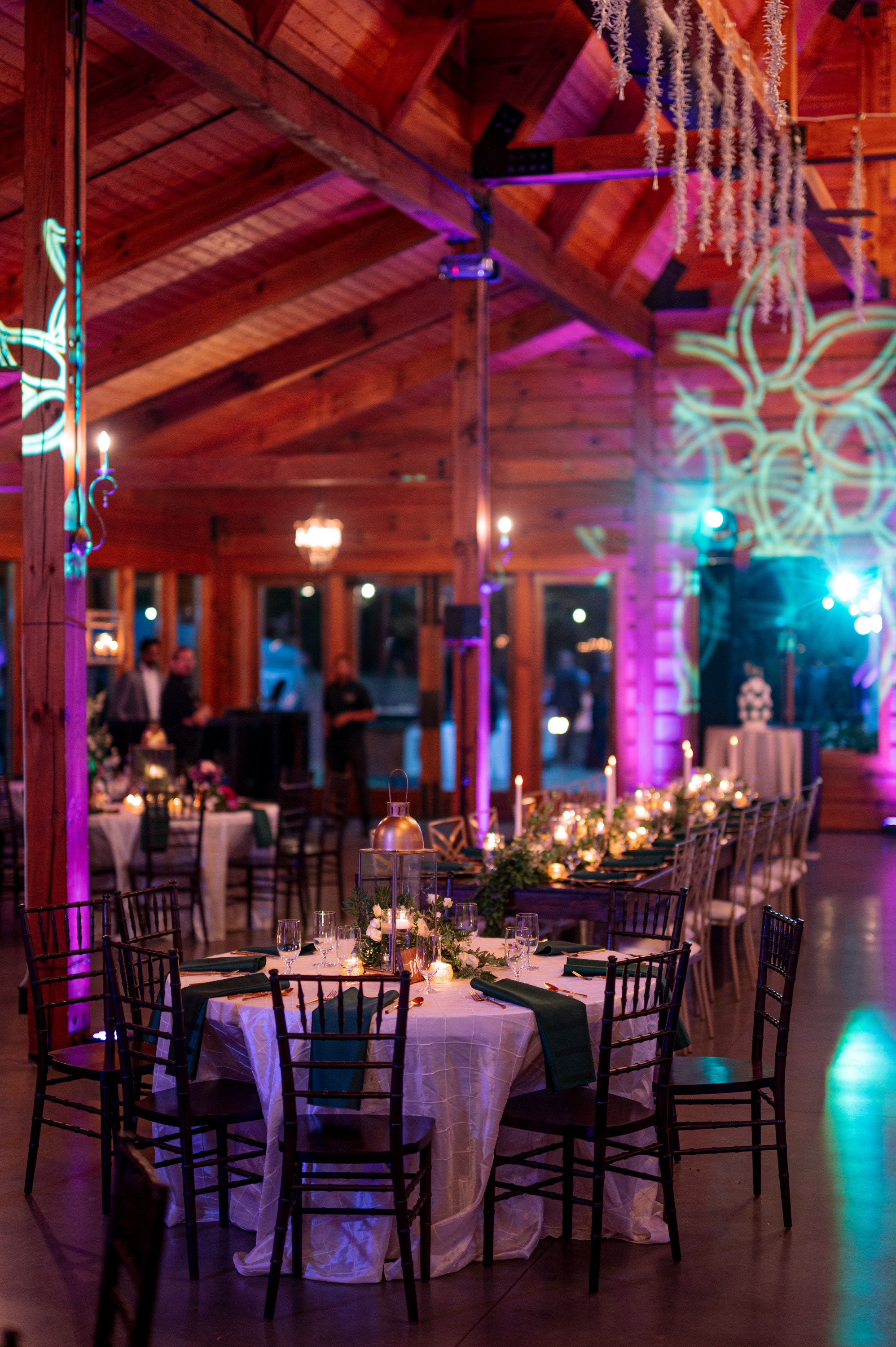 a room with tables and chairs and a chandel