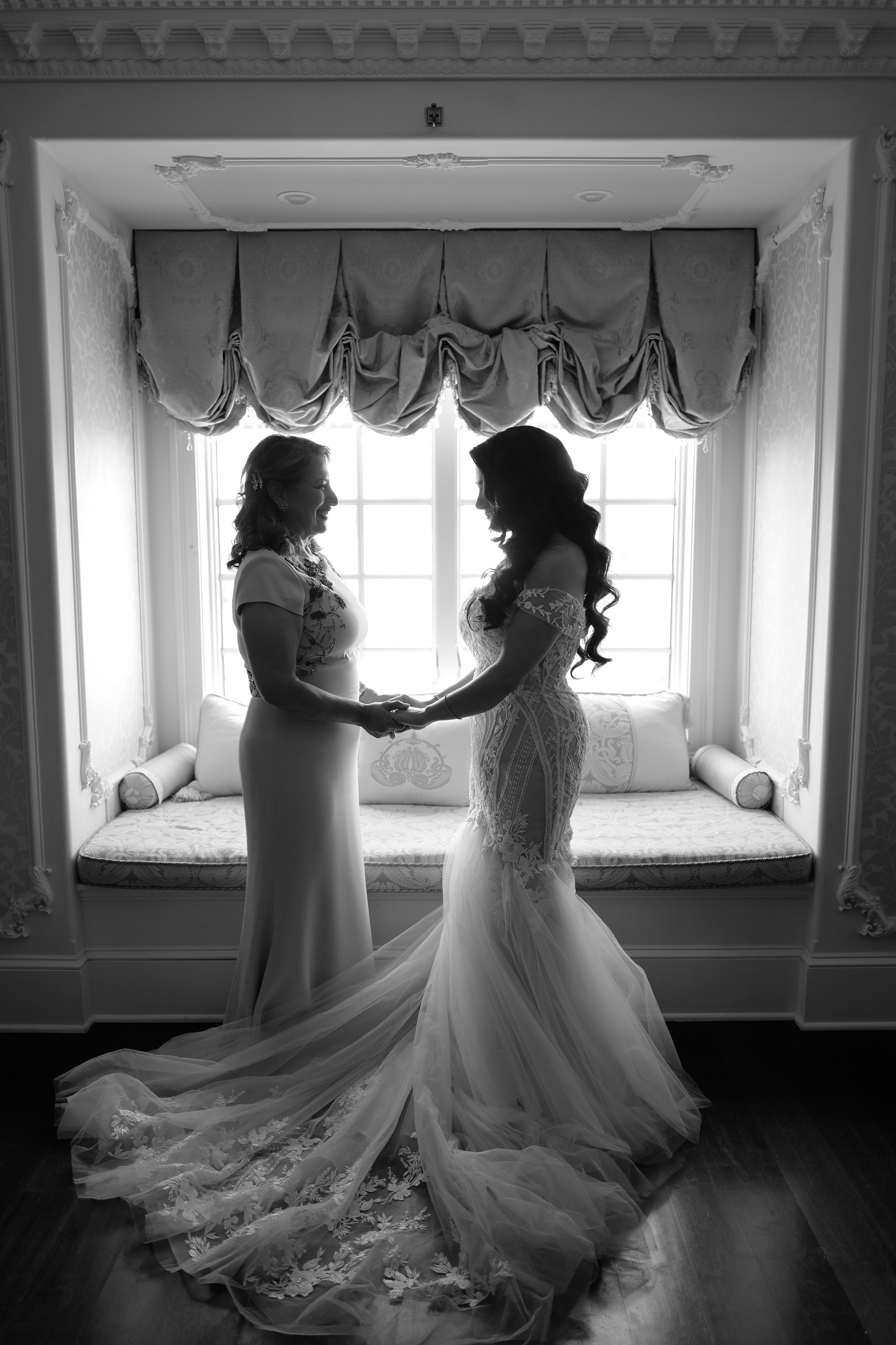 two brides in front of a window