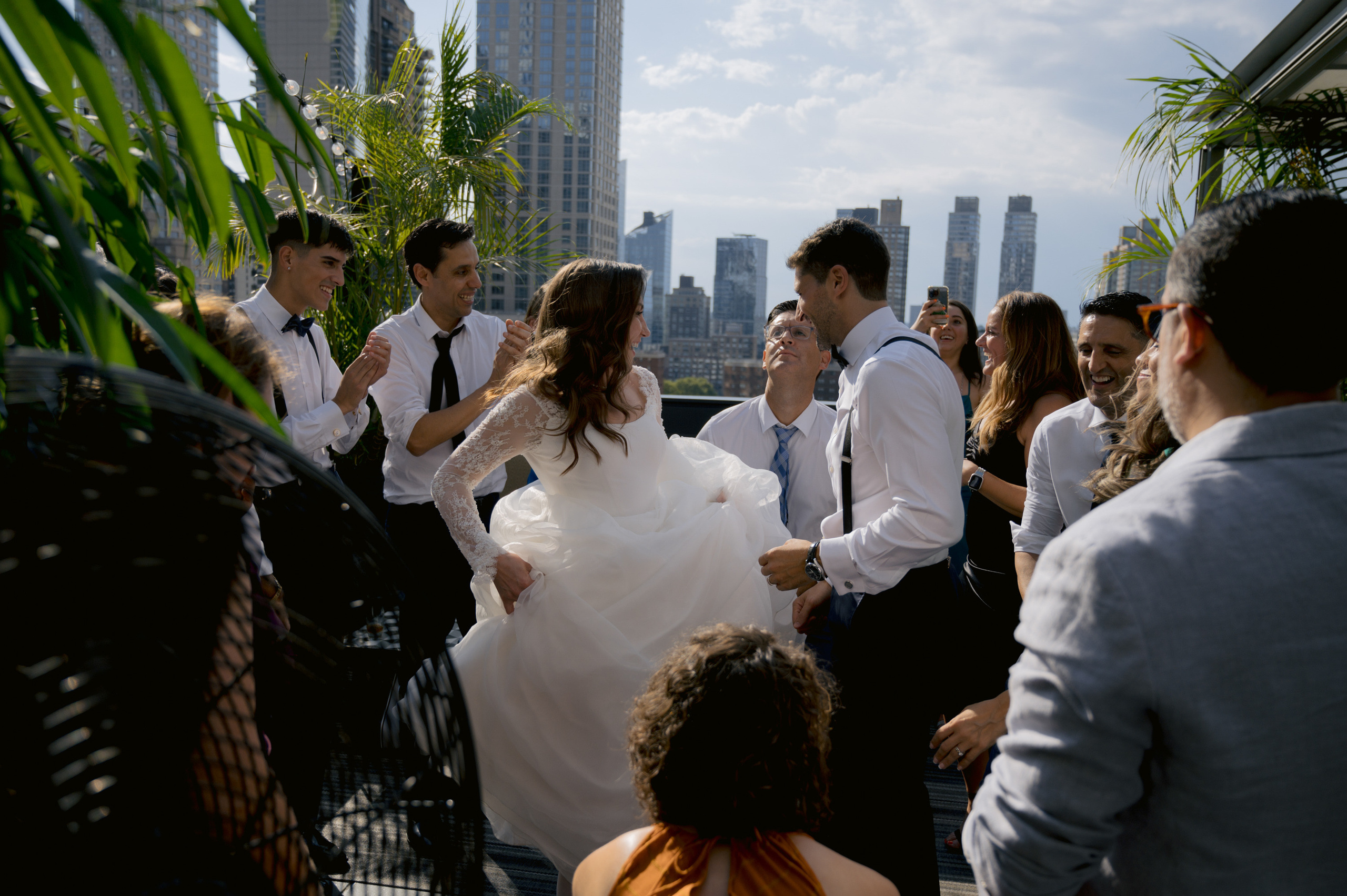 a group of people standing around a woman in a white dress